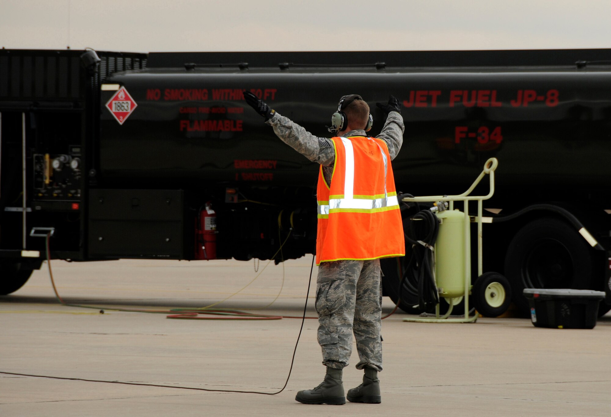 A crew chief with the 188th Aircraft Maintenance Squadron marshals an A-10C Thunderbolt II “Warthog” in preparation for a “hot-pit” refuel at the 188th Fighter Wing during a Unit Training Assembly Nov. 6. (U.S. Air Force photo by Airman 1st Class Hannah Landeros/188th Fighter Wing Public Affairs)