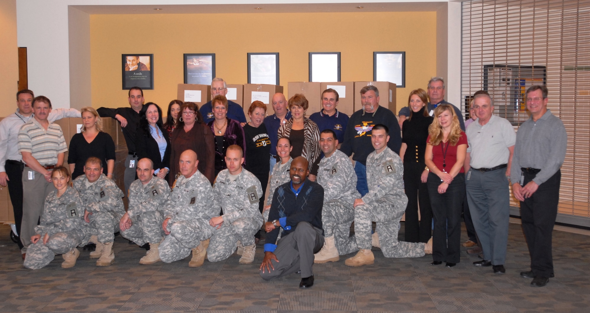 Soldiers and civilians pose for a group photo after preparing more than 120 care packages for deployed troops, part of the Boxes 4 Baghdad effort Nov. 17. (U.S. Army photo by Capt. Antonia Greene/Released)