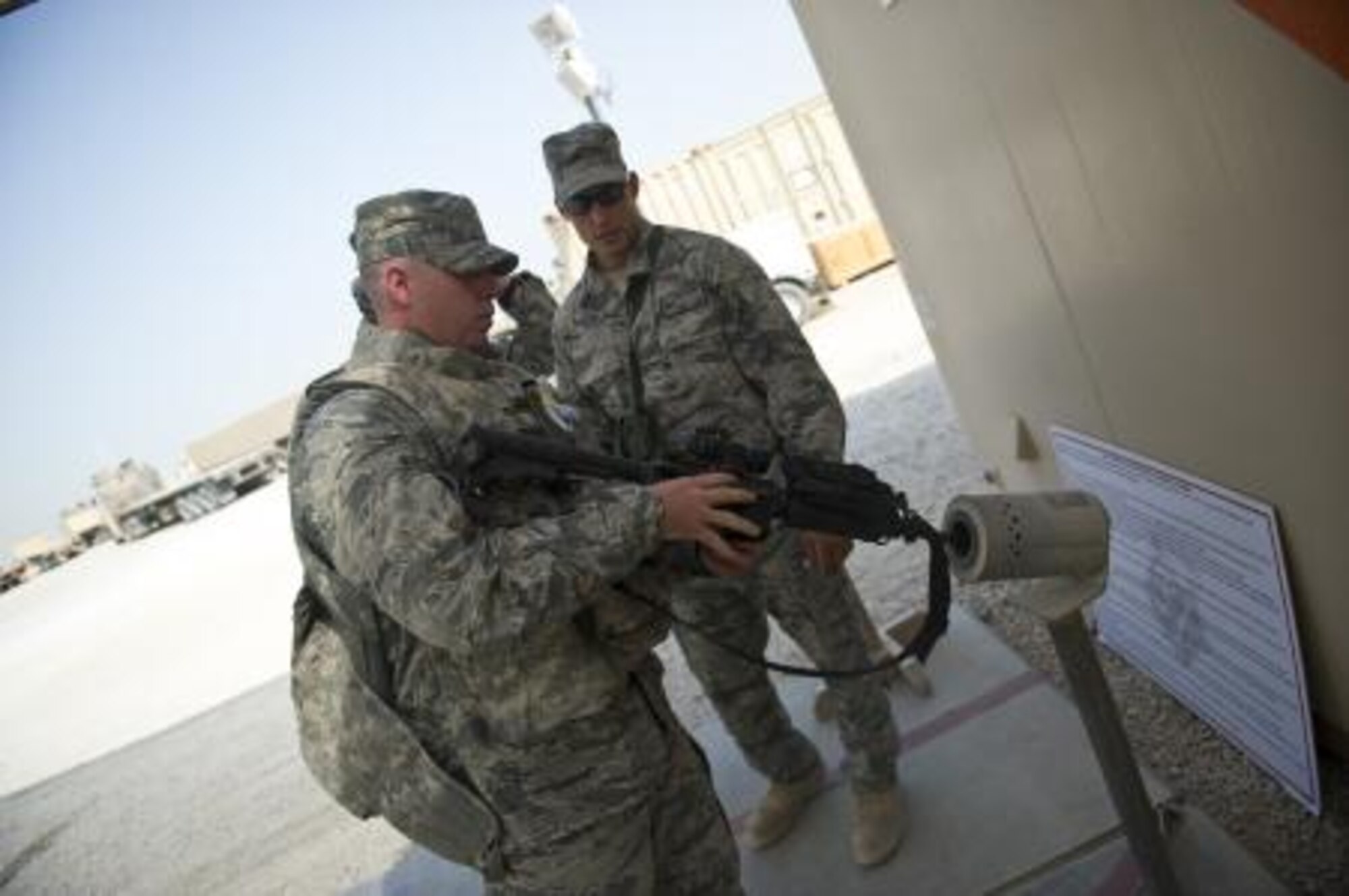 Air Force Staff Sgt. Joseph Worrell, 70th Medium Truck Detachment, vehicle operator and lead navigator for the convoy, clears his weapon before starting a six day mission. During the mission, Worrell and his unit hauled more than 225,000 pounds of equipment out of Iraq in support of the Dec. 31 deadline. (U.S. Air Force photo by Master Sgt. Jeffrey Allen/Released)
