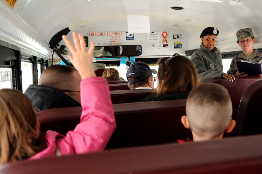 Laveda Murkins, daughter of Tech. Sgt. Jonathan Murkins of Grand Forks Air Force Base, raises her hand during a roll call before going to the next location of the deployment line on GFAFB, N.D., Nov. 19. The base hosted a deployment line for children of affiliated military families to get a feel of the process when a parent deploys.  (U.S. Air Force photo by Senior Airman Amanda N. Grabiec)