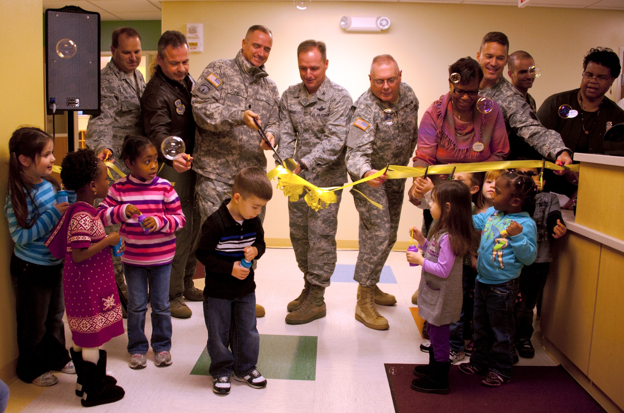 Col. John Wood, Joint Base McGuire-Dix-Lakehurst commander, along with servicemembers' children and other senior leaders cut the ribbon on the new Dix Child Development Center Nov. 17 here. The new CDC was specifically designed with children in mind, incorporating modern design technology for safety. The facility can house 180 children and is located near the Garden Terrace housing area and Fort Dix Elementary School, closer to the population it serves. Individuals are from left to right: Col. Chris Patterson, Col. Paul Murphy, LTC Tim Connelly, Col. John Wood, COL Mark Wilhite, Rilda Jones, COL Joseph Whitlock, Darleen White. (U.S. Air Force Photo by Airman Ryan Throneberry/Released)