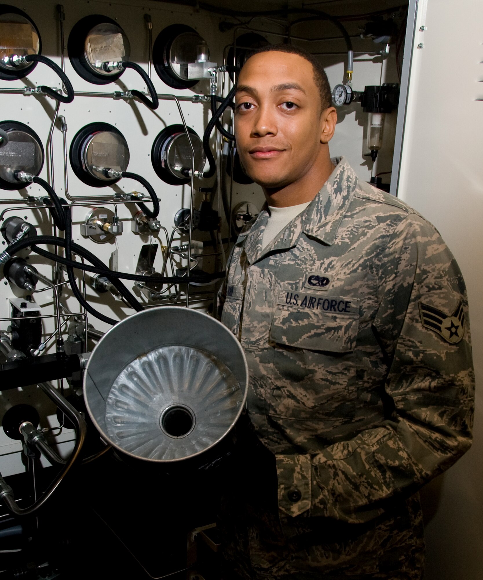 Senior Airman Justin Horn, 60th Maintenance Squadron hydraulics shop, stands in the back of a hydraulic test bench, used to service and inspect aircraft parts. Horn finds satisfaction in watching aircraft takeoff and knowing he played a part in its safe departure. (U.S. Air Force photo/Heide Couch)