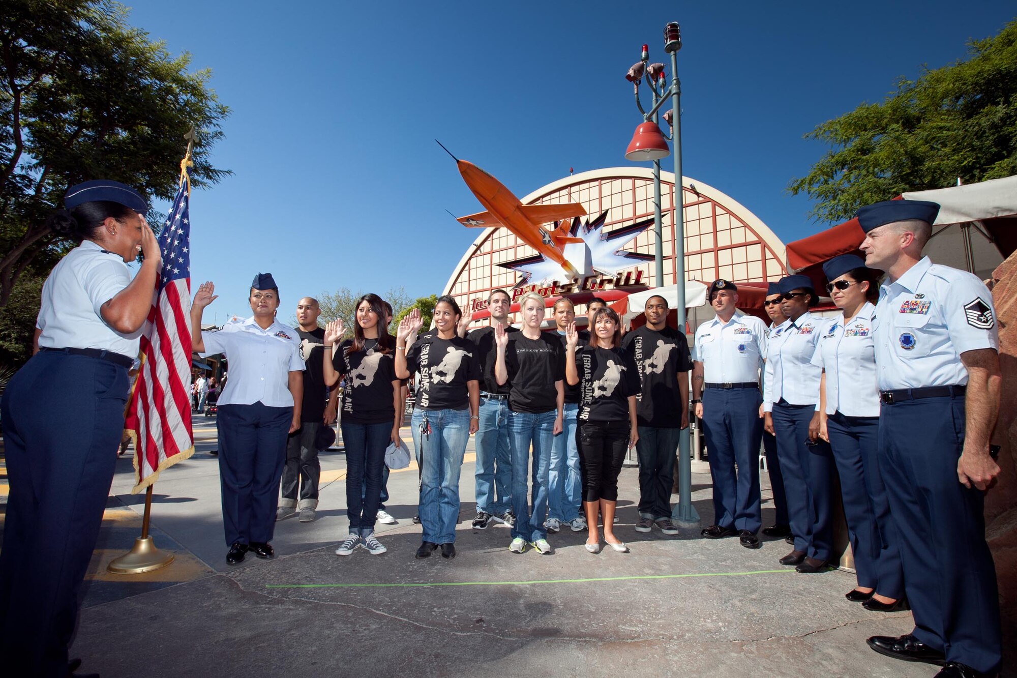 Maj. Jaclyn Chatwick, commander of the Western Recruiting Squadron, gives the oath of enlistment to 11 new Air Force Reserve recruits on Oct. 12, 2011. Disneyland Resort hosted the swearing-in ceremony at Condor Flats inside Disney California Adventure park, Calif., an area dedicated to the rich history of California aviation. The new recruits experienced “Soarin’ Over California” following their military oath, an attraction taking them on an aerial tour over some of California’s extraordinary landmarks. Senior Master Sgt. Alejandra Enriquez, 452nd Force Support Squadron, re-enlisted during the ceremony. 