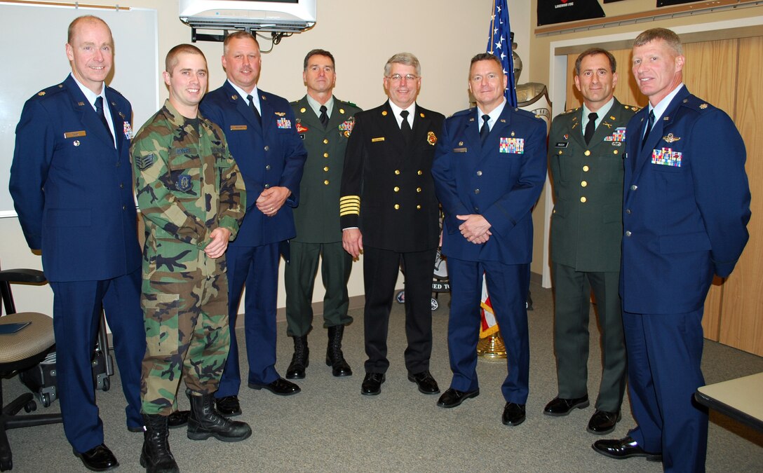Airmen and Soldiers from Joint Base Lewis-McChord, Wash., stand with West Pierce Fire & Rescue chief Ken Sharp at a fire commissioner meeting, Nov. 15, 2011 in Lakewood, Wash. Reservists from the 446th Airlift Wing out of McChord Field were presented with certificates of appreciation for their military service while being employed with WPFR. (Courtesy photo)