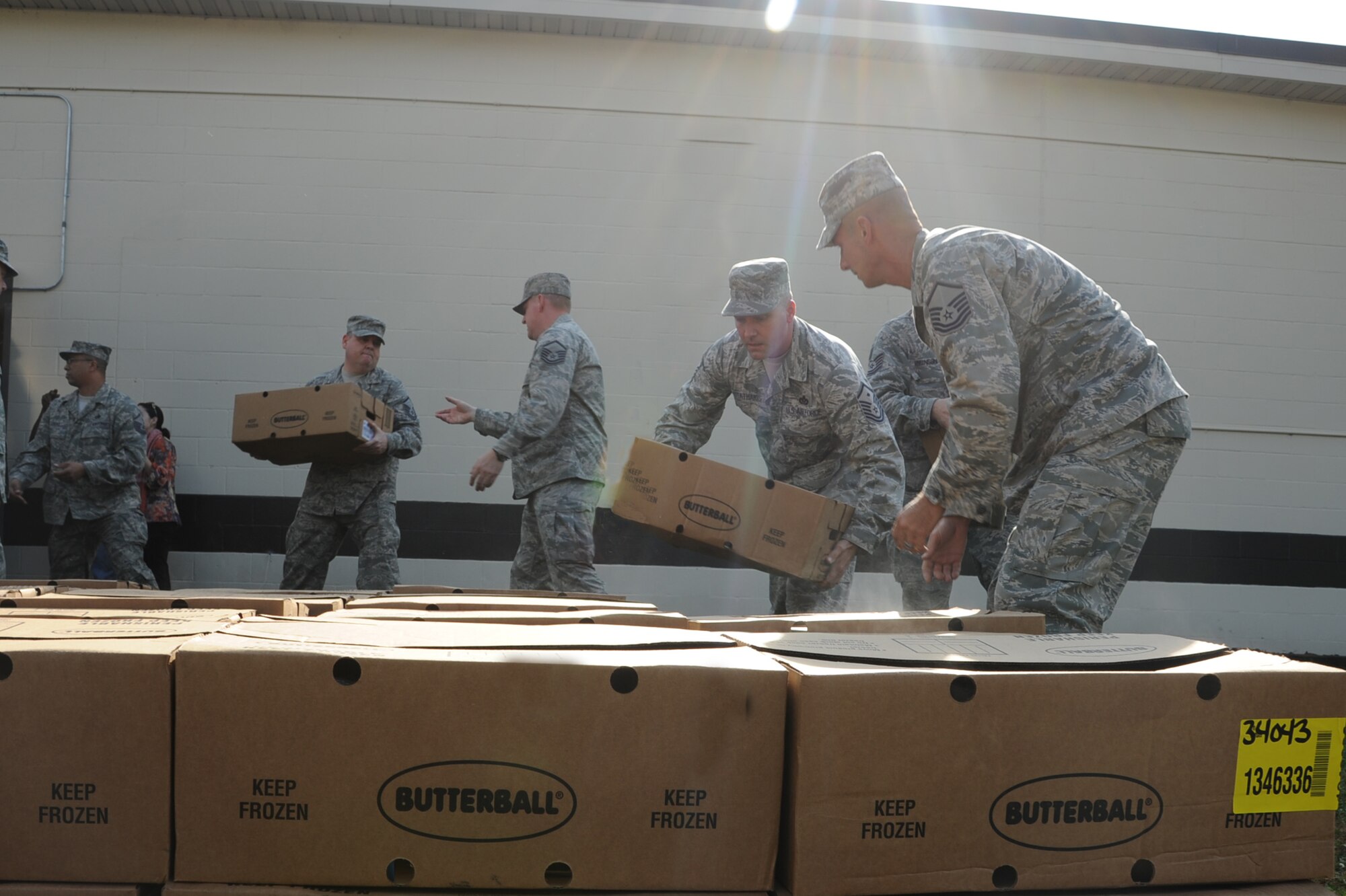 Airmen from Seymour Johnson Air Force Base, N.C., move Butterball turkey boxes in an assembly line, Nov. 21, 2011. Butterball delivered 270 frozen turkeys to the First Sergeants Council who will then distribute them along with other donated items to Airmen in their agencies. (U.S. Air Force photo by Senior Airman Whitney Stanfield)