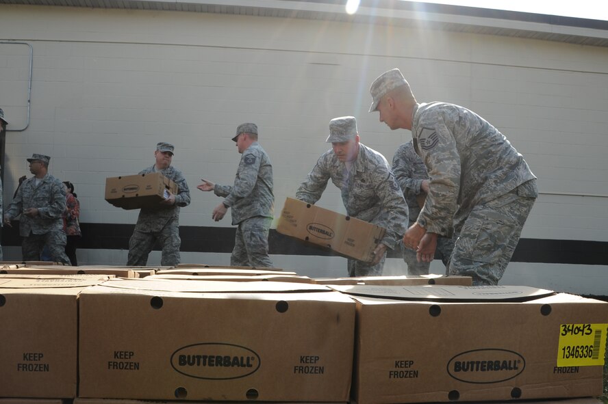 Airmen from Seymour Johnson Air Force Base, N.C., move Butterball turkey boxes in an assembly line, Nov. 21, 2011. Butterball delivered 270 frozen turkeys to the First Sergeants Council who will then distribute them along with other donated items to Airmen in their agencies. (U.S. Air Force photo by Senior Airman Whitney Stanfield)