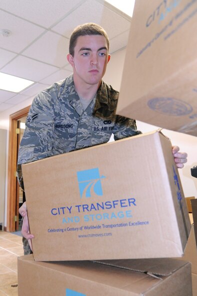 Airman 1st Class Jason Birdsong picks up a box during the food drive on Seymour Johnson Air Force Base, N.C., Nov. 21, 2011. The First Sergeant's Council has organized the Thanksgiving food drive with help from Butterball, local companies and Airmen on base.  Birdsong is a 4th Logistics Readiness Squadron fire truck maintenance journeyman from Thomaston, Ga. (U.S. Air Force photo by Senior Airman Whitney Stanfield)