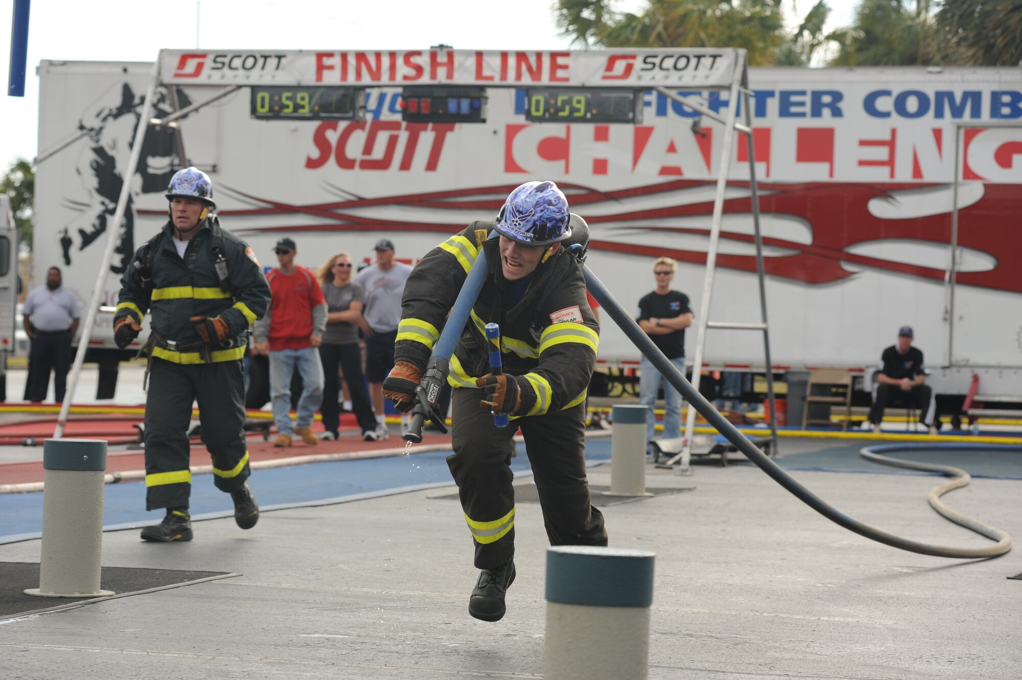 Anthony Beaudry hauls a water-laden firehose to its target Nov. 17, 2011, during the World Firefighter Combat Challenge XX in Myrtle Beach, S.C.  Beaudry and his fellow firefighters from Whiteman Air Force Base, Mo., came in second in the world among men's relay teams. (U.S. Air Force photo/John Van Winkle)