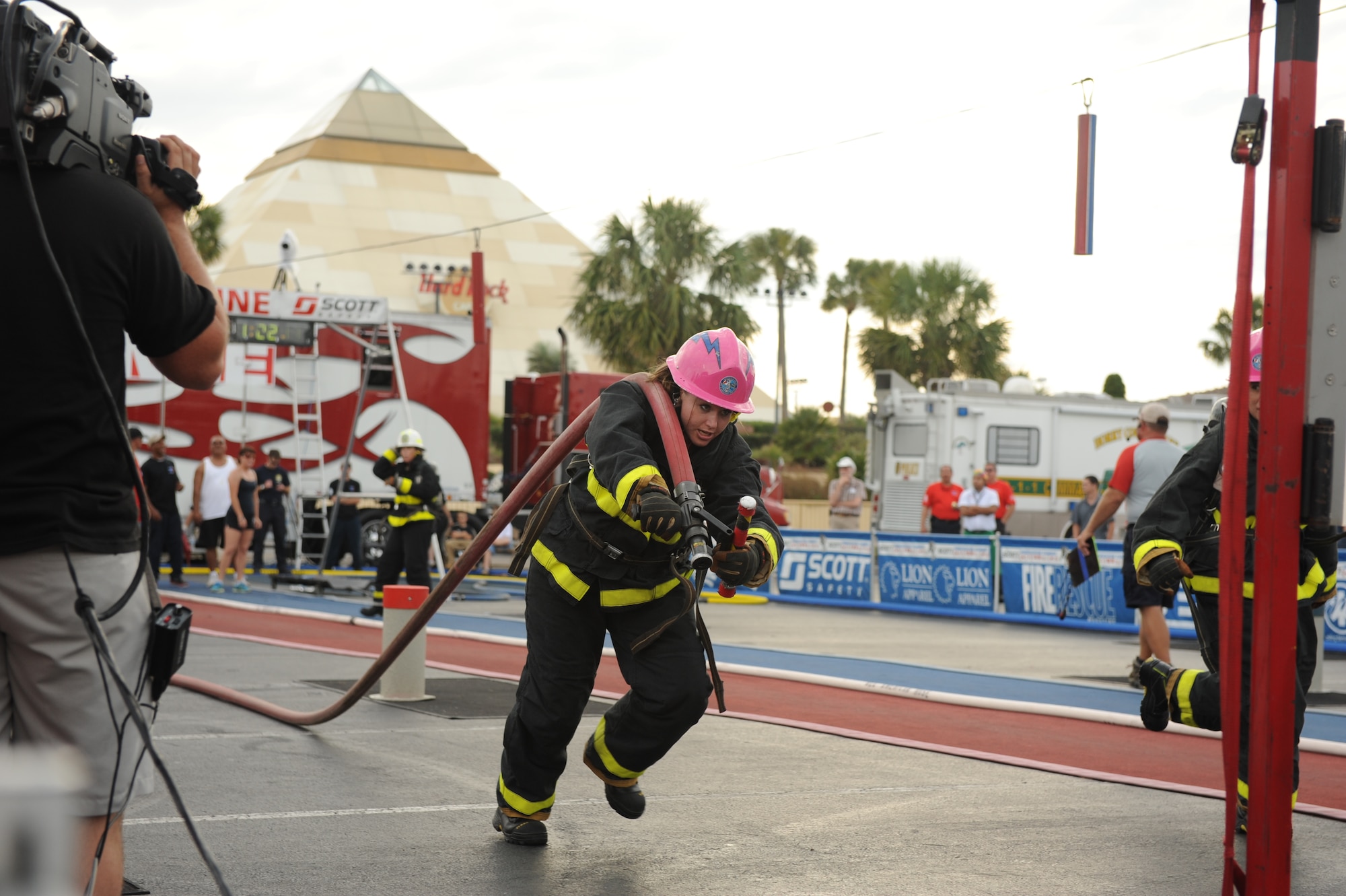 Senior Airman Jessica Condon of the U.S. Air Force Academy Fire Department drags a fire hose 75 feet Nov. 16, 2011, at the World Firefighter Combat Challenge XX in Myrtle Beach, S.C. (U.S. Air Force photo/John Van Winkle)