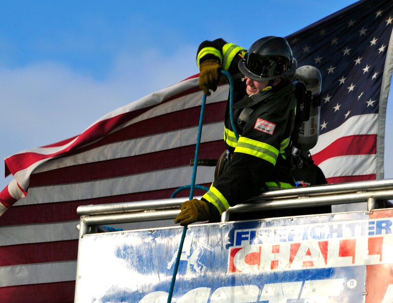 Staff Sgt. Steven Thomas, 20th Civil Engineer Squadron firefighter, pulls the hose up the five-story tower during his leg of the five-man relay at the Scott Firefighter Combat Challenge world competition at Myrtle Beach, S.C., Nov. 15, 2011. The Shaw Air Force Base firefighters competed against 180 teams from across the world. (U.S. Air Force photo/Airman 1st Class Daniel Phelps/Released)