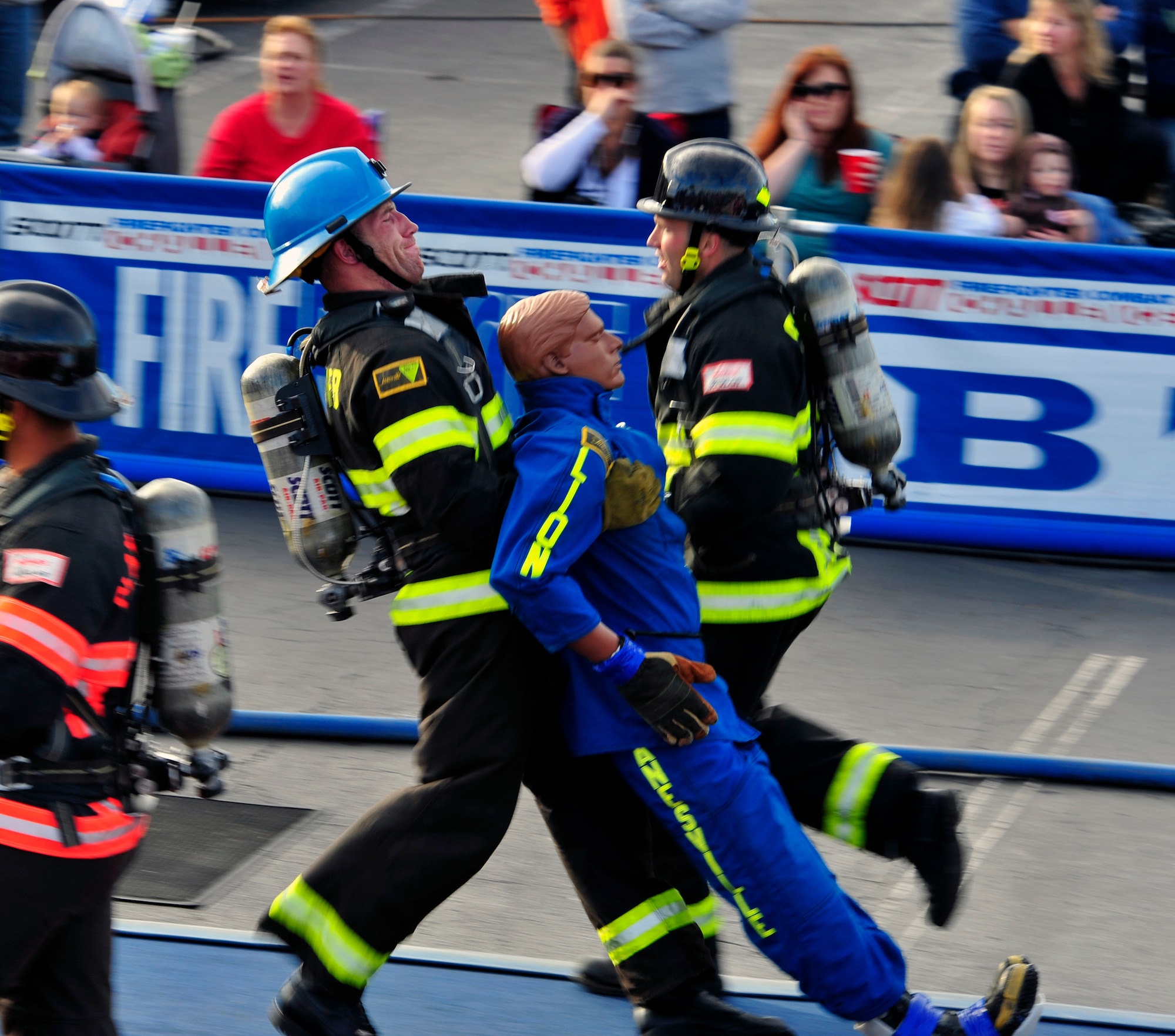 Staff Sgt. Chastin Warner, 20th Civil Engineer Squadron firefighter, drags a 175-pound rescue dummy towards the finish line while Staff Sgt. Steven Thomas, 20th CES firefighter, encourages him at the Scott Firefighter Combat Challenge world competition at Myrtle Beach, S.C. Nov. 15, 2011. The 20th CES firefighters competed againt 180 firefighter teams from across the world. (U.S. Air Force photo/Airman 1st Class Daniel Phelps/Released)