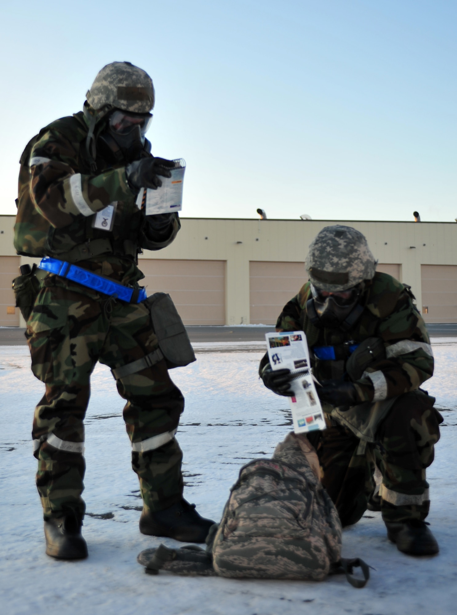 Arctic Warriors check their Airman's Manual to identify and report unexploded ordnance during Exercise Polar Force 11-10 at Joint Base Elmendorf-Richardson, Alaska, Nov. 17,  2011. The exercise is made up of a variety of scenarios which test the arctic warriors' ability to handle real world situations. (U.S. Air Force photo/Staff Sgt. Sheila deVera)