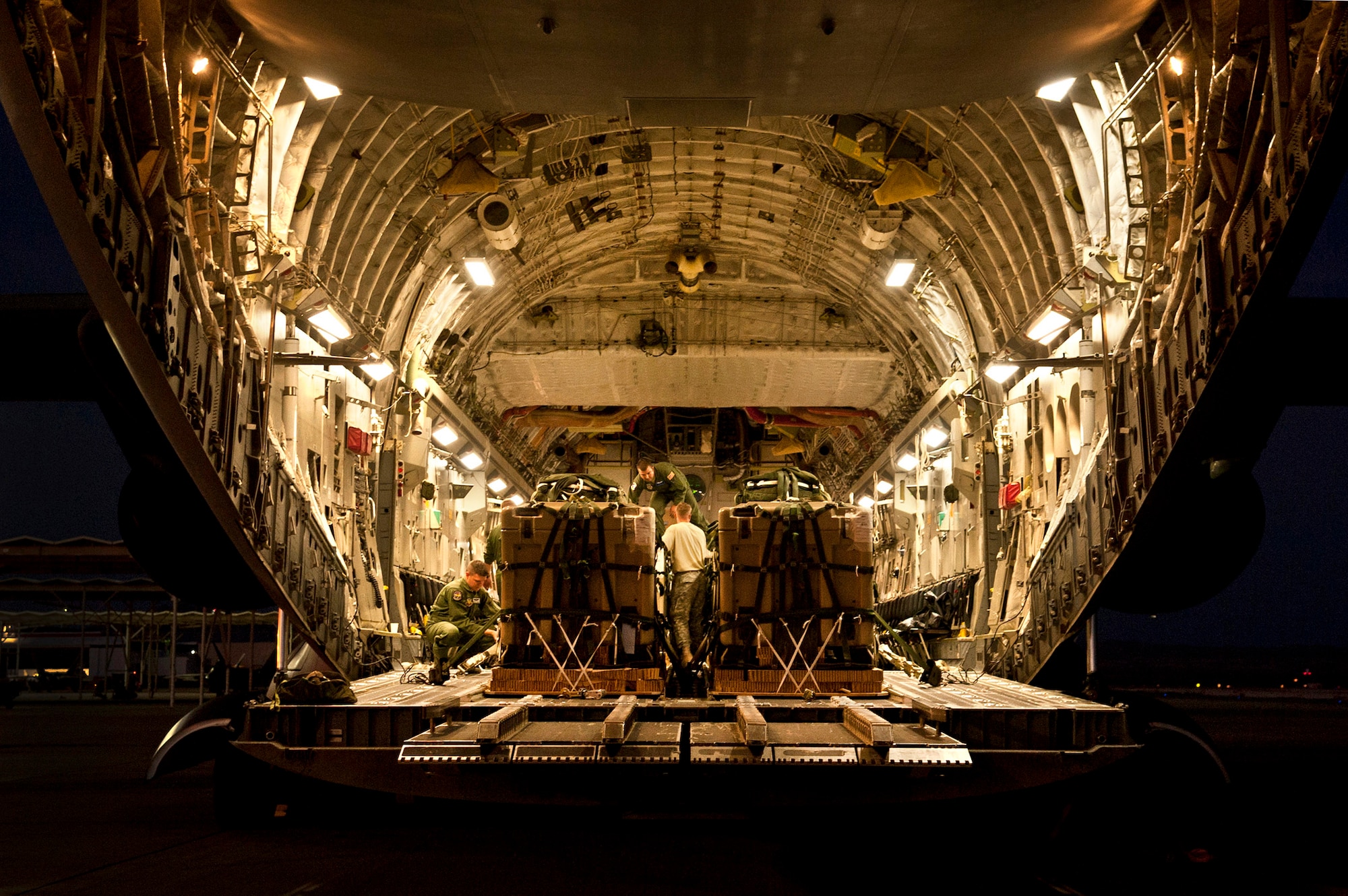 U.S. Air Force Airmen secure cargo on to a C-17 Globemaster during Mobility Air Forces Exercise on Nov. 15, 2011, at Nellis Air Force Base, Nev. C-17 and C-130 Hercules cargo aircraft will assemble in aerial formations over the Nevada Test and Training Range to conduct air and ground operations as part of the bi-annual U.S. Air Force Weapons School Mobility Air Forces Exercise. (U.S. Air Force photo by Airman 1st Class George Goslin/Released)