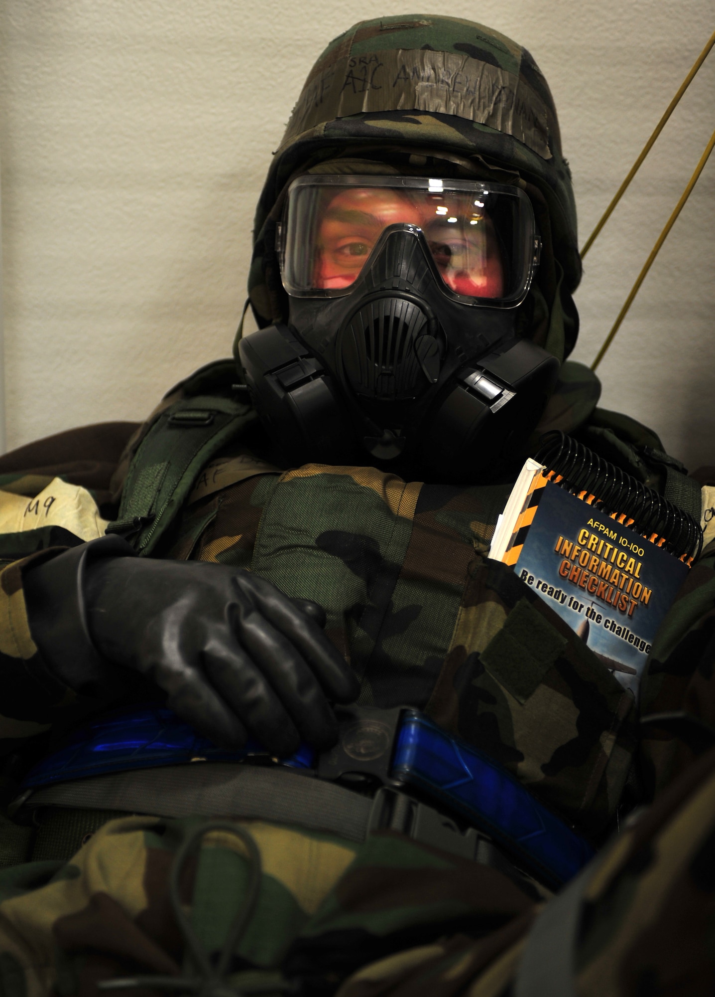 Senior Airman Andrew Dynan, 3rd Aircraft Maintenance Squadron, takes cover while under a simulated chemical attack during Exercise Polar Force 11-10 at Joint Base Elmendorf-Richardson, Alaska, Nov. 17, 2011. The exercise is made up of a variety of scenarios which test the arctic warriors' ability to handle real world situations. (U.S. Air Force photo/Staff Sgt. Sheila deVera)  