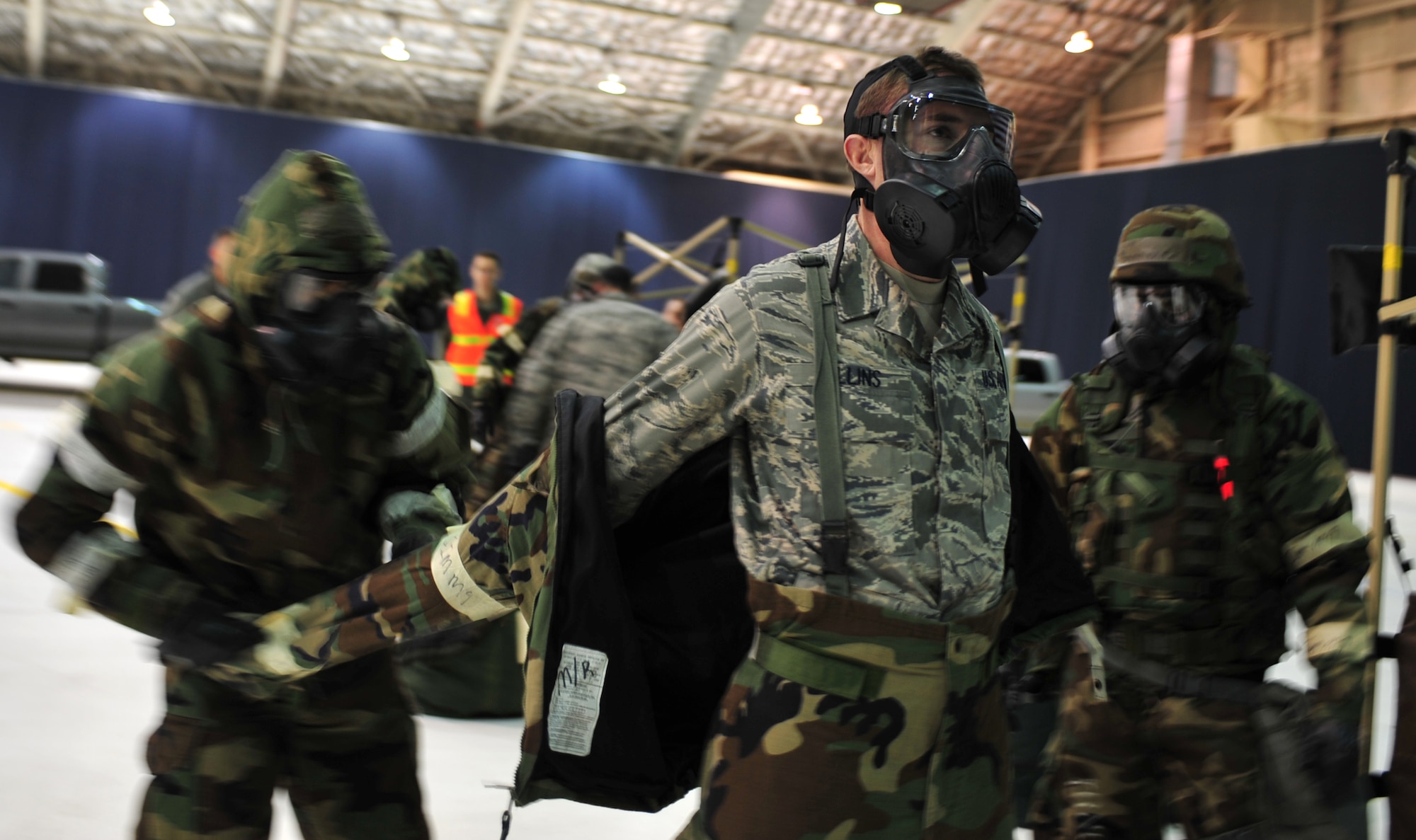 Arctic Warriors go through the decontamination line during Exercise Polar Force 11-10 at Joint Base Elmendorf-Richardson, Alaska, Nov. 17, 2011. The exercise is made up of a variety of scenarios which test the arctic warriors' ability to handle real world situations. (U.S. Air Force photo/Staff Sgt. Sheila deVera)