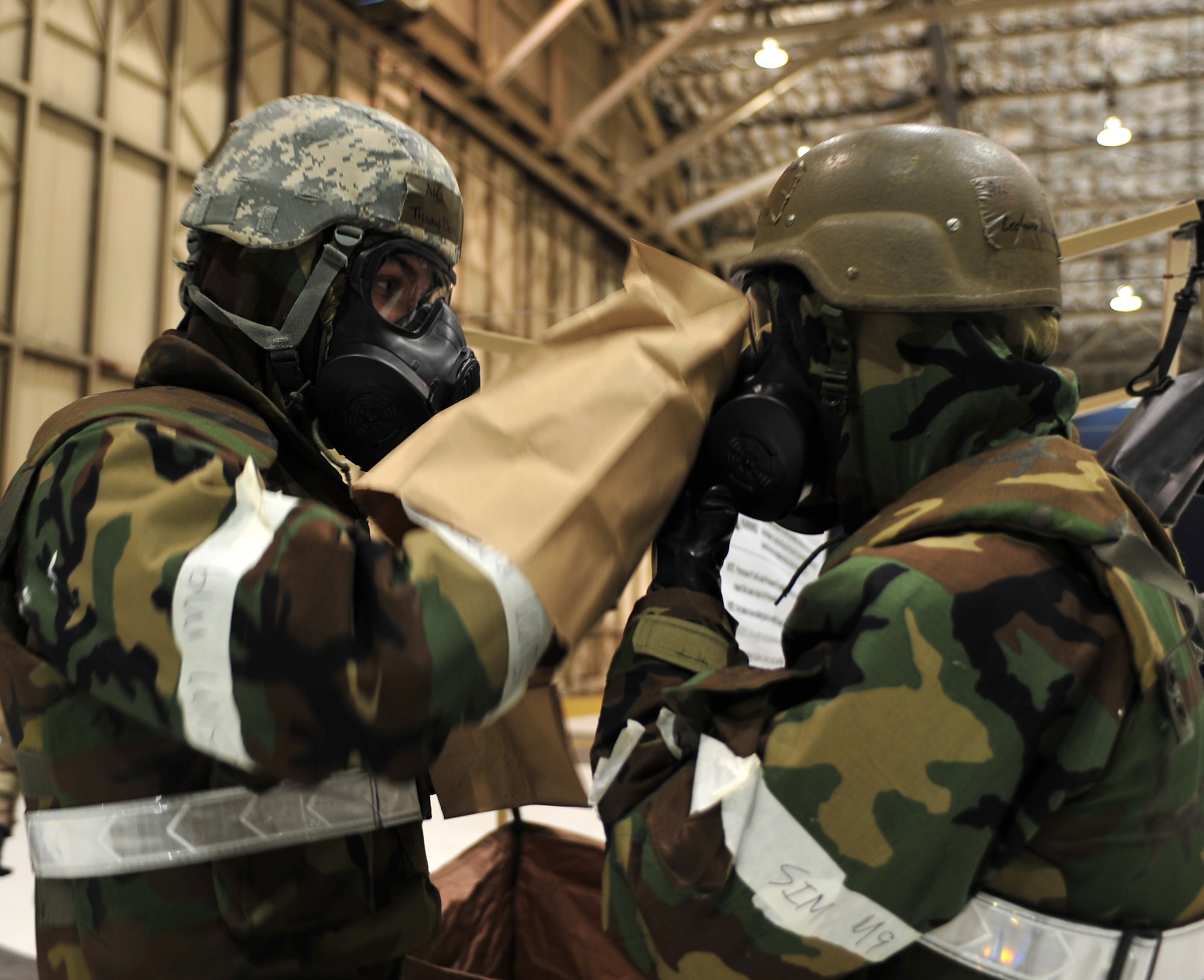 Arctic Warriors go through the decontamination line during Exercise Polar Force 11-10 at Joint Base Elmendorf-Richardson, Alaska, Nov. 17, 2011. The exercise is made up of a variety of scenarios which test the arctic warriors' ability to handle real world situations. (U.S. Air Force photo/Staff Sgt. Sheila deVera)