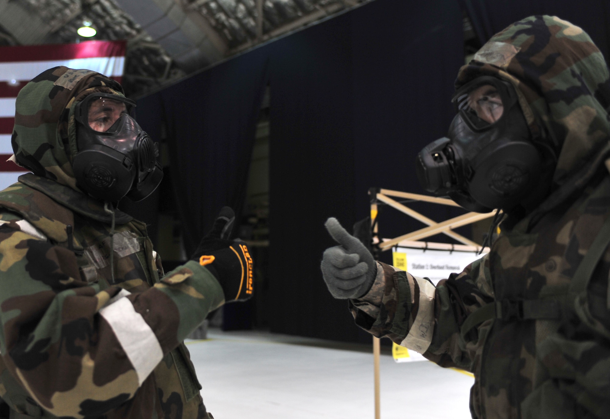 An Arctic Warriors give each other thumbs-up to ensure their Mission Oreinted Protective gear is properly secured during Exercise Polar Force 11-10 at Joint Base Elmendorf-Richardson, Alaska, Nov. 17, 2011. The exercise is made up of a variety of scenarios which test the arctic warriors' ability to handle real world situations. (U.S. Air Force photo/Staff Sgt. Sheila deVera)