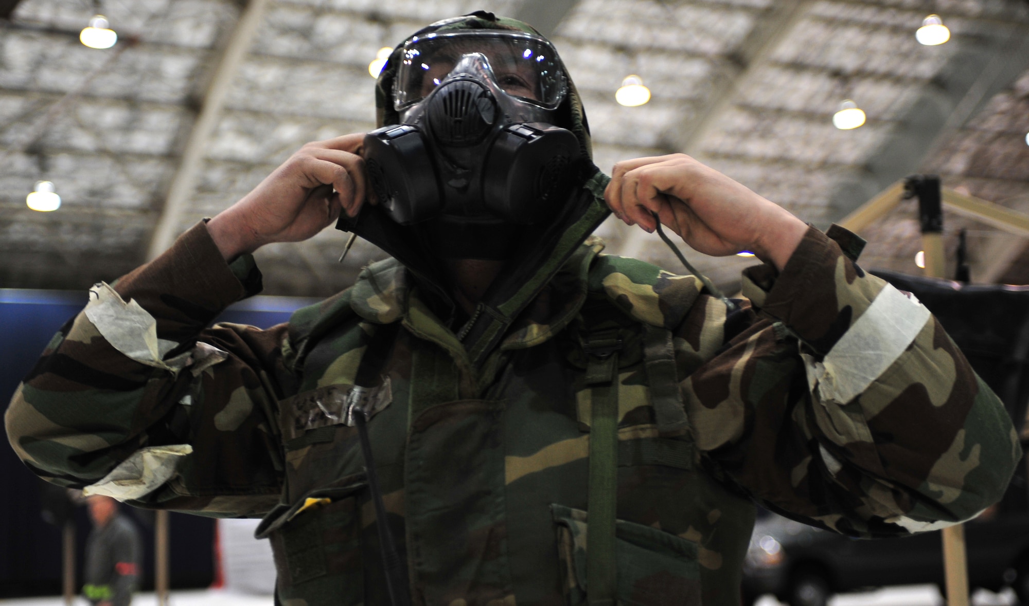 An Arctic Warrior dons his Mission Oriented Protective Posture gear during a missile attack during Exercise Polar Force 11-10 at  Joint Base Elmendorf-Richardson, Alaska, Nov. 17, 2011. The exercise is made up of a variety of scenarios which test the ability to handle real world situations. (U.S. Air Force photo/Staff Sgt. Sheila deVera)