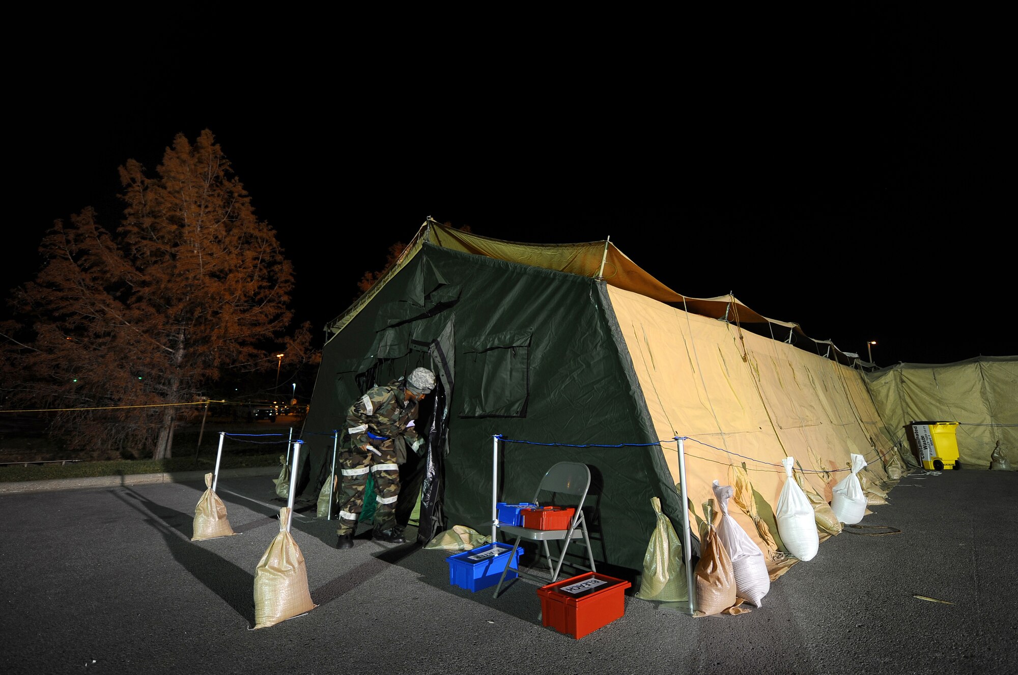 U.S. Air Force Staff Sgt. Andrea Perry, 55th Medical Group, exits the medical tent while participating in an operational readiness exercise at Offutt Air Force Base, Neb., Nov. 15.  Airmen with the 55 MDG spent three nights exercising their ability to accomplish missions at deployed locations around the world.  (U.S. Air Force photo by Josh Plueger/Released)