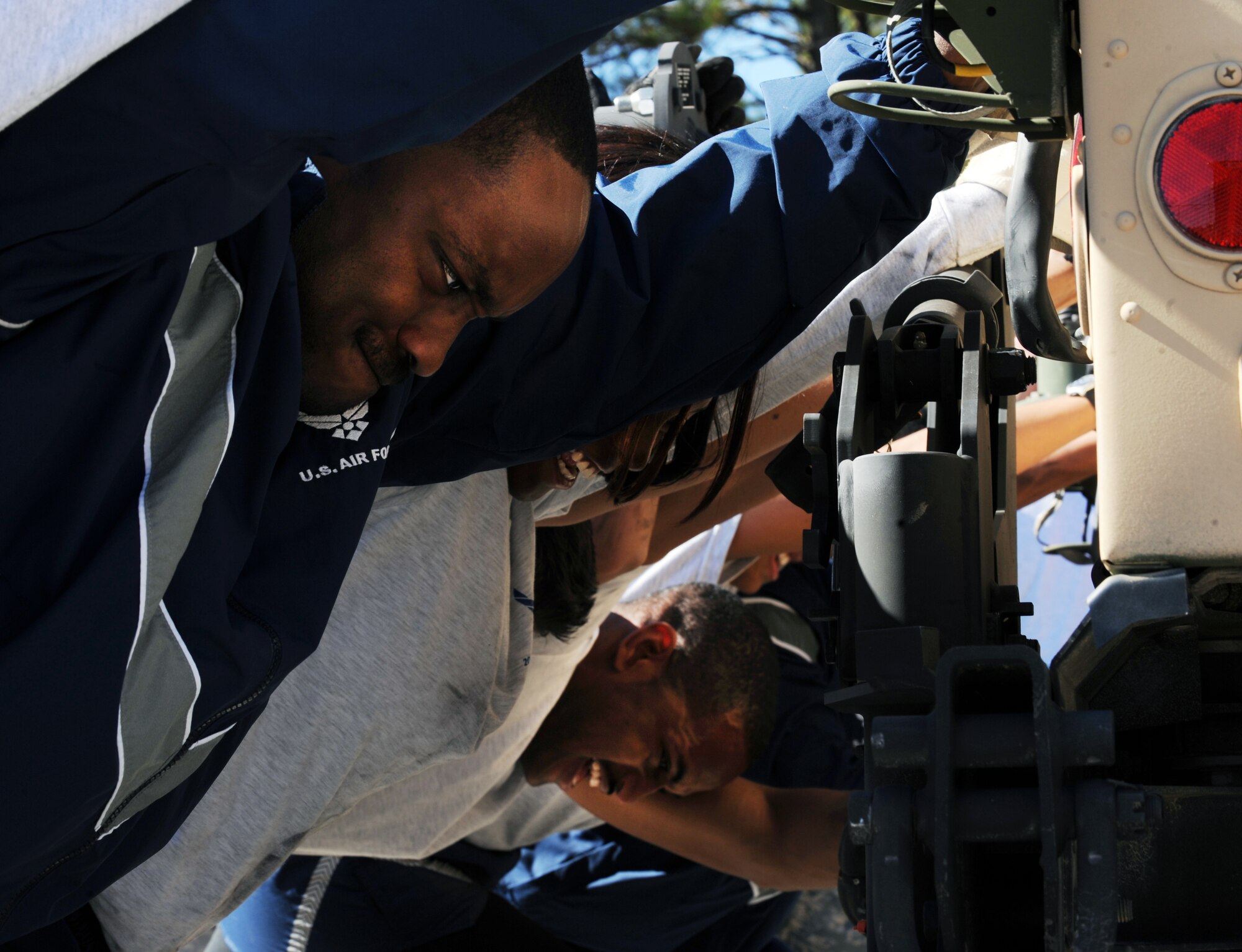 U.S. Air Force Staff Sgt. Jairus McCain, 20th Logistics Readiness Squadron equipment technician, Senior Airman Alicia Batista, 20th LRS commander's secretary, and Senior Airman Samuel Wilhite, 20th LRS traffic management office logistician push a Humvee during the 20th Mission Support Group Warrior Challenge, Shaw Air Force Base, S.C., Nov. 18, 2011. The 20th MSG held a Warrior Challenge to boost the morale and camaraderie of the Airmen. The 20th MSG Warrior Challenge consisted of a physical training challenge, three-mile rucksack march and an obstacle course. (U.S. Air Force photo by Airman 1st Class Tabatha Duarte/Released)