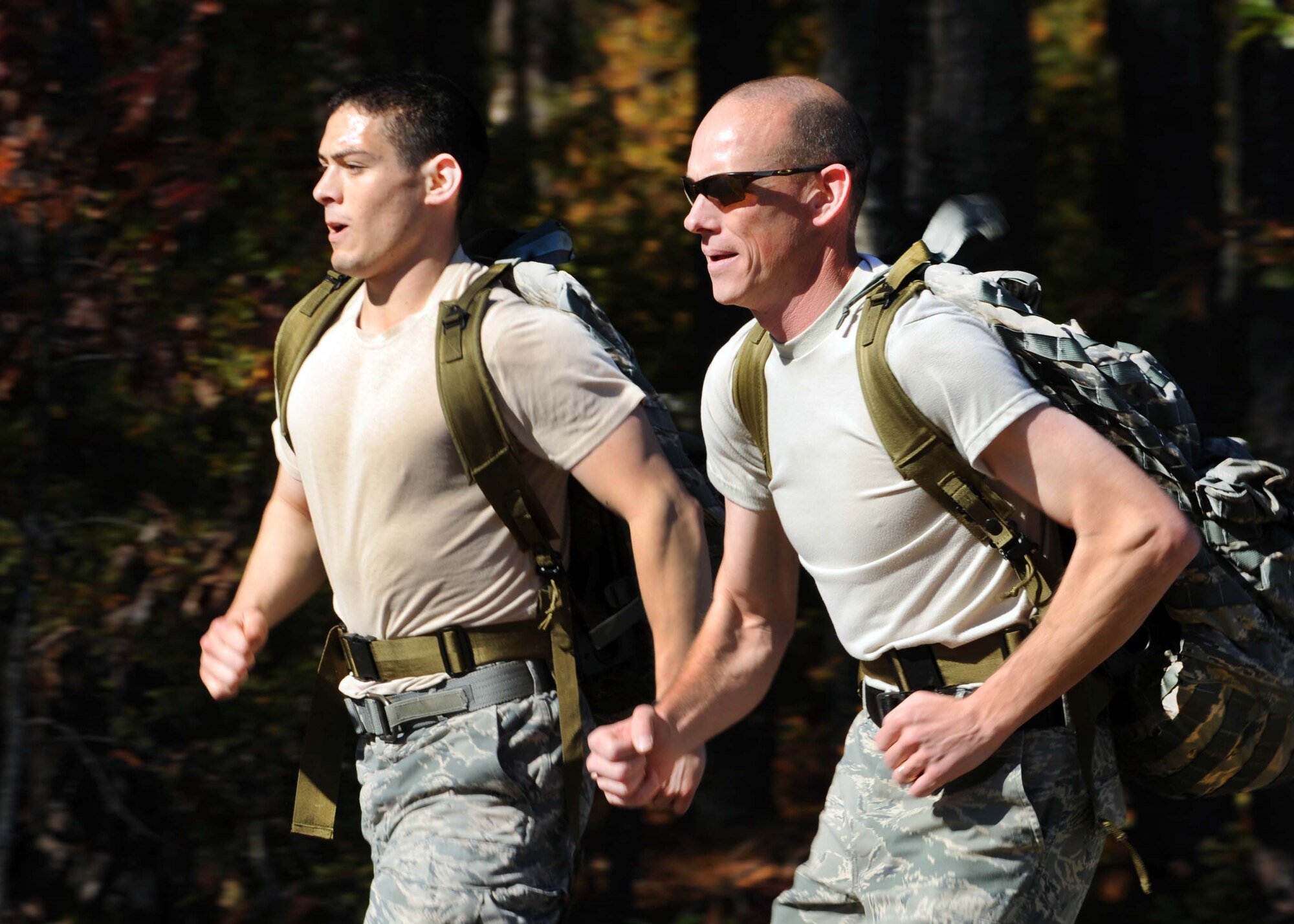 U.S. Air Force Senior Airman Eugene Kozlovsky, 20th Security Forces Squadron patrolman, and Master Sgt. Stephen Hunter, 20th SFS quality control, run the three-mile rucksack race, Shaw Air Force Base, S.C., Nov. 18, 2011. The 20th MSG held a Warrior Challenge to boost the morale and camaraderie of the Airmen. The 20th MSG Warrior Challenge consisted of a physical training challenge, three-mile rucksack march and an obstacle course. (U.S. Air Force photo by Airman 1st Class Tabatha Duarte/Released)