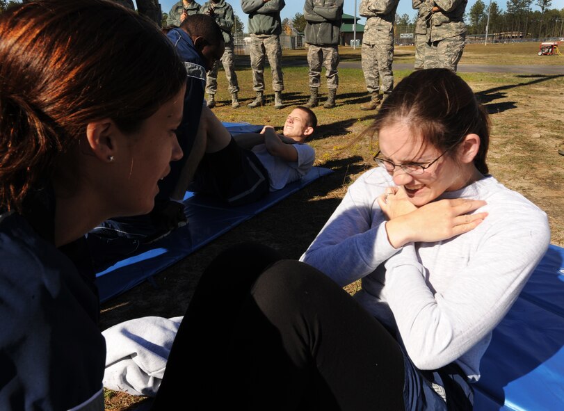 U.S. Air Force Staff Sgt. Terri Brown, 20th Logistics Readiness Squadron equipment accountability journeyman, and Airman 1st Class Jeremy Spencer, 20th LRS material control and vehicle maintenance, participate in the physical training challenge, while Staff Sgt. Ellamarie Powell, 20th LRS unit training manager, and Staff Sgt. Jairus McCain, 20th LRS equipment technician, administer the PT Challenge, at Shaw Air Force Base, S.C., Nov. 18, 2011. The 20th MSG held a Warrior Challenge to boost the morale and camaraderie of the Airmen. The 20th MSG Warrior Challenge consisted of a physical training challenge, three-mile rucksack march and an obstacle course. (U.S. Air Force photo by Airman 1st Class Tabatha Duarte/Released)