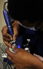 MINOT AIR FORCE BASE, N.D. --Senior Airman Justin Phillips, 5th Medical Operations Squadron dental lab technician, completes a custom porcelain bridge, here Nov. 16. The dental lab customizes a variety of products such as crowns, bridges and dentures to assist in the provision of oral health care. (U.S. Air Force Photo/Airman 1st Class Desiree Esposito)