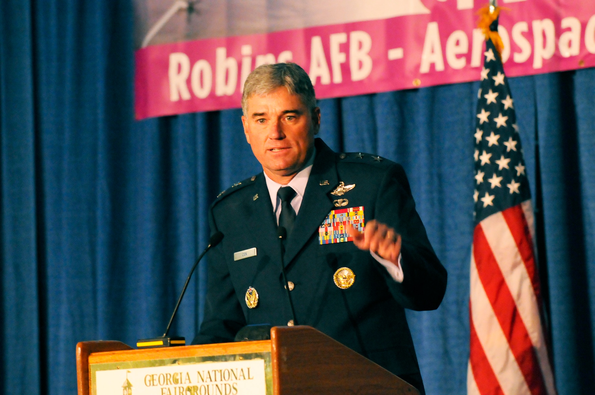 Requirements Symposium keynote speaker Maj. Gen. Samuel Cox, U.S. Transportation Command Strategy, Policy, Programs and Logistics director, points out that in 2011, 90 million pounds of supplies were air dropped in Afghanistan, equating to 2,500 missions supporting 10 to 15 forward operating bases. U. S. Air Force photo by Sue Sapp