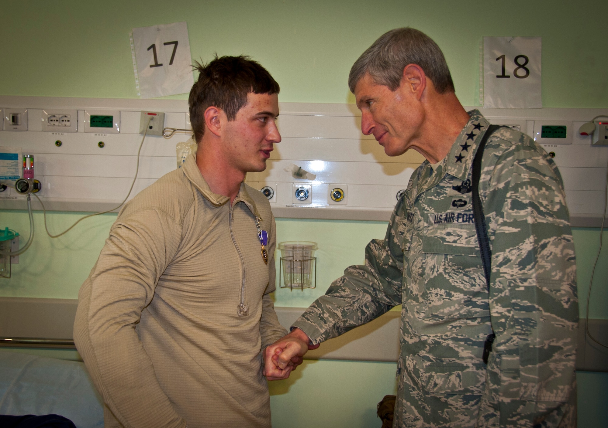 KANDAHAR AIRFIELD, Afghanistan -- Air Force Chief of Staff Gen. Norton Schwartz speaks with Senior Airman Taras Ivaniuk at Kandahar Airfield, Nov. 16, 2011. Ivaniuk received a Purple Heart and a Combat Action Medal for his actions during a recent personnel recovery mission. (U.S. Air Force photo/Senior Airman David Carbajal)