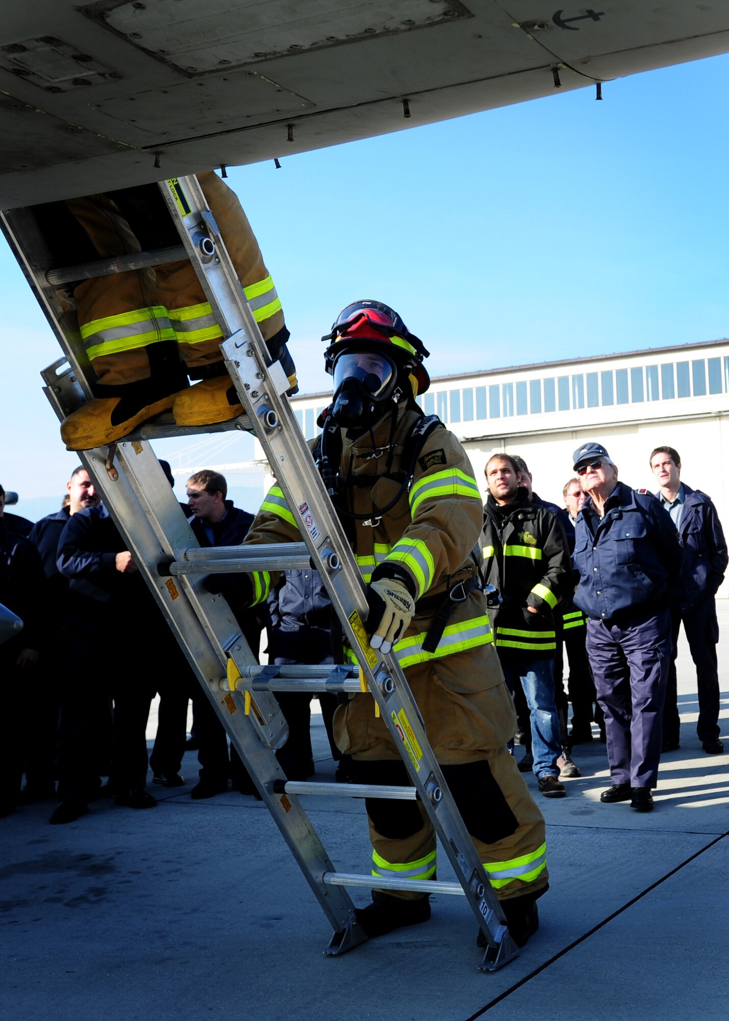 Firefighters of the 31st Civil Engineer Squadron participate in an F-16 Fighting Falcon egress procedures and familiarization exercise Nov. 19 at Aviano Air Base, Italy. The exercise aimed to help Slovenian firefighters familiriaze with U.S. Air Force firefighting procedures. (U. S. Air Force Photo/Senior Airman Evelyn Chavez)