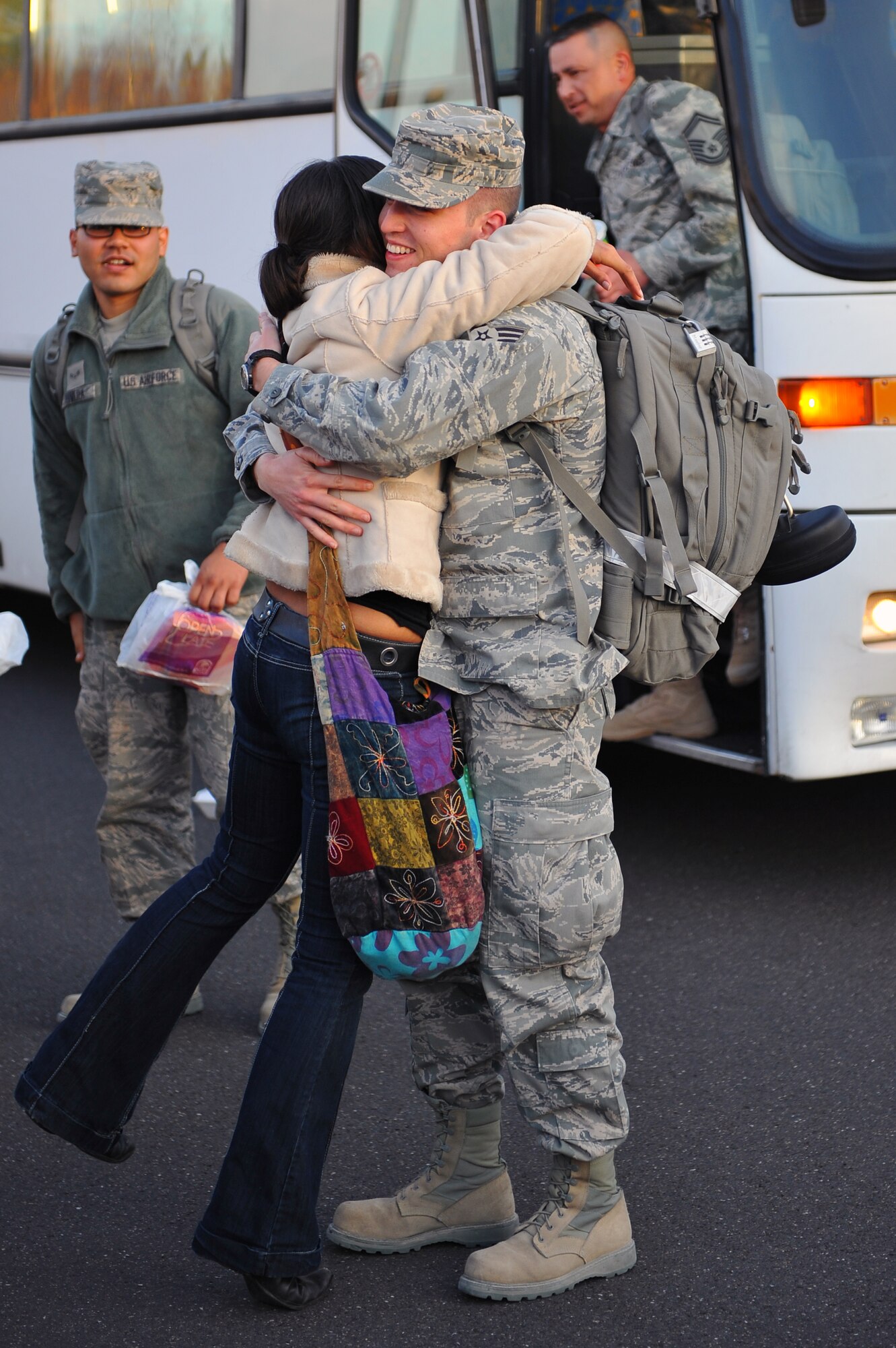 SPANGDAHLEM AIR BASE, Germany – Airman 1st Class Logan Romero, 606th Air Control Squadron communications technician, embraces his wife, Rebecca, here Nov. 21 upon his return from a deployment to Iraq. Airmen from the 606th ACS returned from deployment and were welcomed home by family and fellow service members at Bldg. 340. The squadron deployed to control airspace by maintaining a deployable radar site, satellite communications and ground-to-air-radios. (U.S. Air Force photo/Airman 1st Class Dillon Davis)