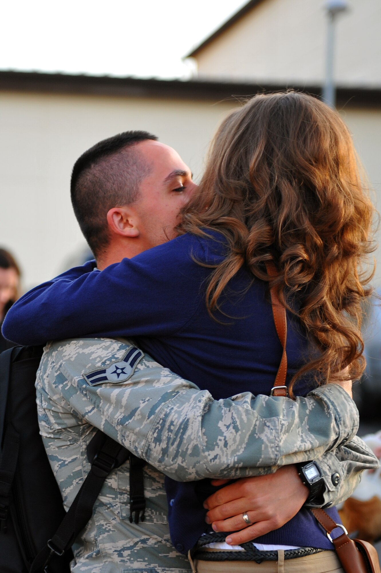 SPANGDAHLEM AIR BASE, Germany – Airman 1st Class Connor Melendez, 606th Air Control Squadron communications technician, embraces his wife, Melissa, here Nov. 21 upon his return from a deployment to Iraq. Airmen from the 606th ACS returned from deployment and were welcomed home by family and fellow service members at Bldg. 340.The squadron deployed to control airspace by maintaining a deployable radar site, satellite communications and ground-to-air-radios. (U.S. Air Force photo/Airman 1st Class Dillon Davis)