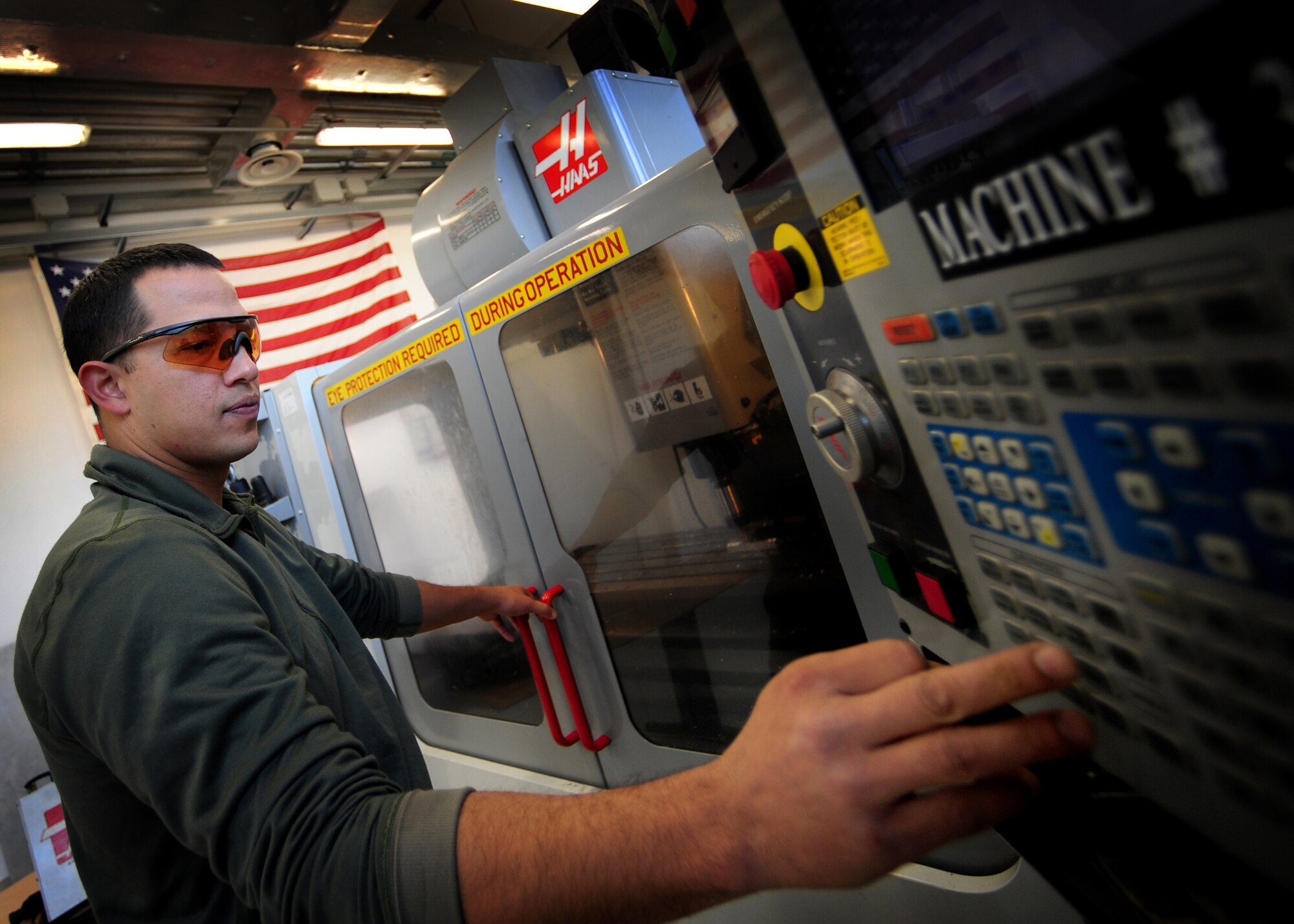 Tech. Sgt. Jesse Swiderek, 31st Maintenance Squadron aircraft metals technology craftsman, fabricates a metal part on a Computer Numeric Controlled (CNC) machine Nov. 21 at Aviano Air Base, Italy.  The CNC machine helps with efficiency when fabricating large amounts of intricate metal parts used for components that need repairing. (U.S Air Force Photo/Senior Airman Evelyn Chavez)