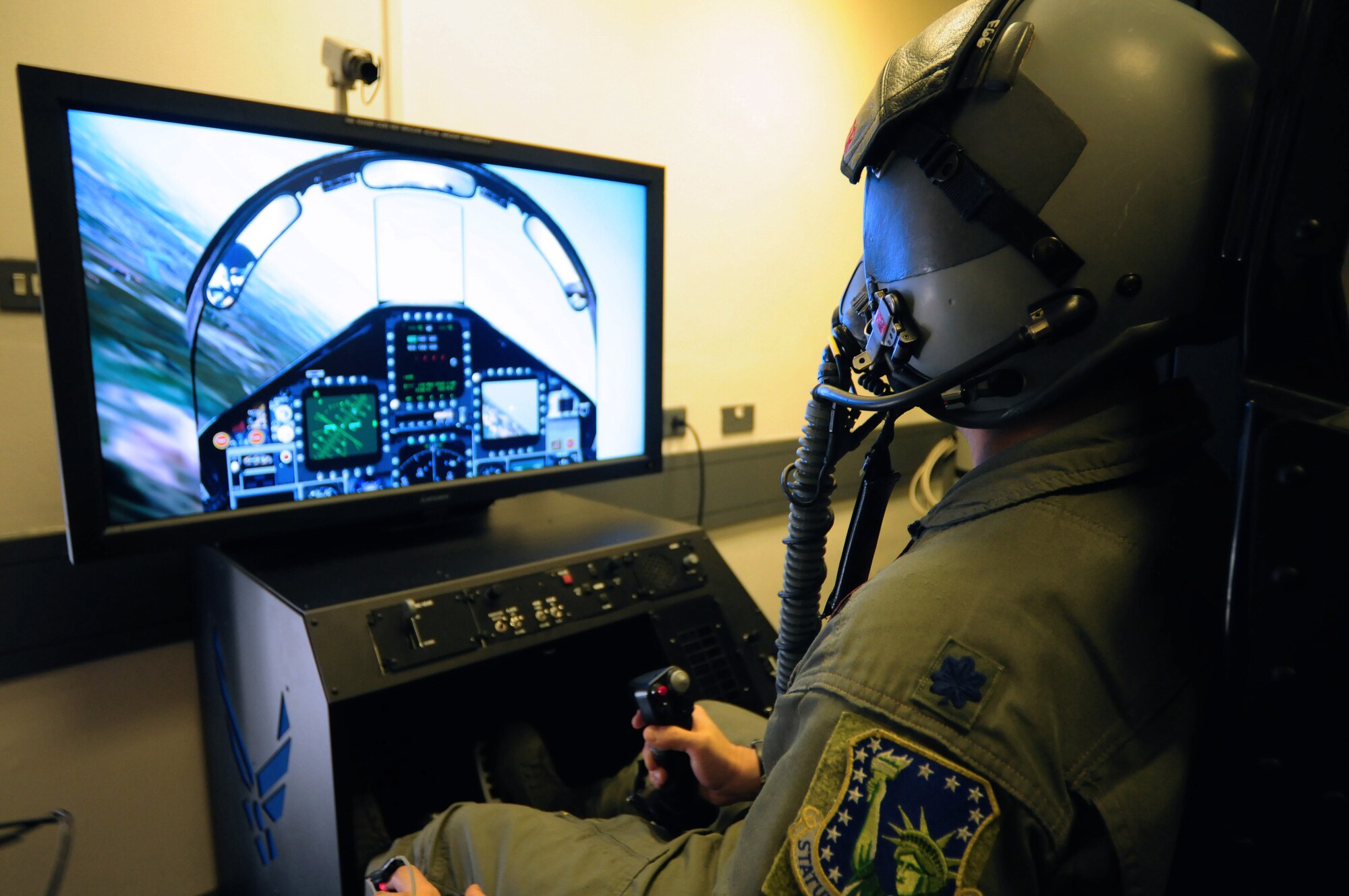 ROYAL AIR FORCE LAKENHEATH, England - Lt. Col. Jonathan Taylor, 494th Fighter Squadron director of operations, flies a simulated F-15 fighter jet using the Reduced Oxygen Breathing Device/Hypoxia Familiarization Trainer, Nov. 18, 2011. The trainer provides aircrew members the ability to still experience a simulated altitude change without the added pressure changes and risks when using an altitude chamber. (U.S. Air Force photo by Senior Airman Lausanne Morgan)