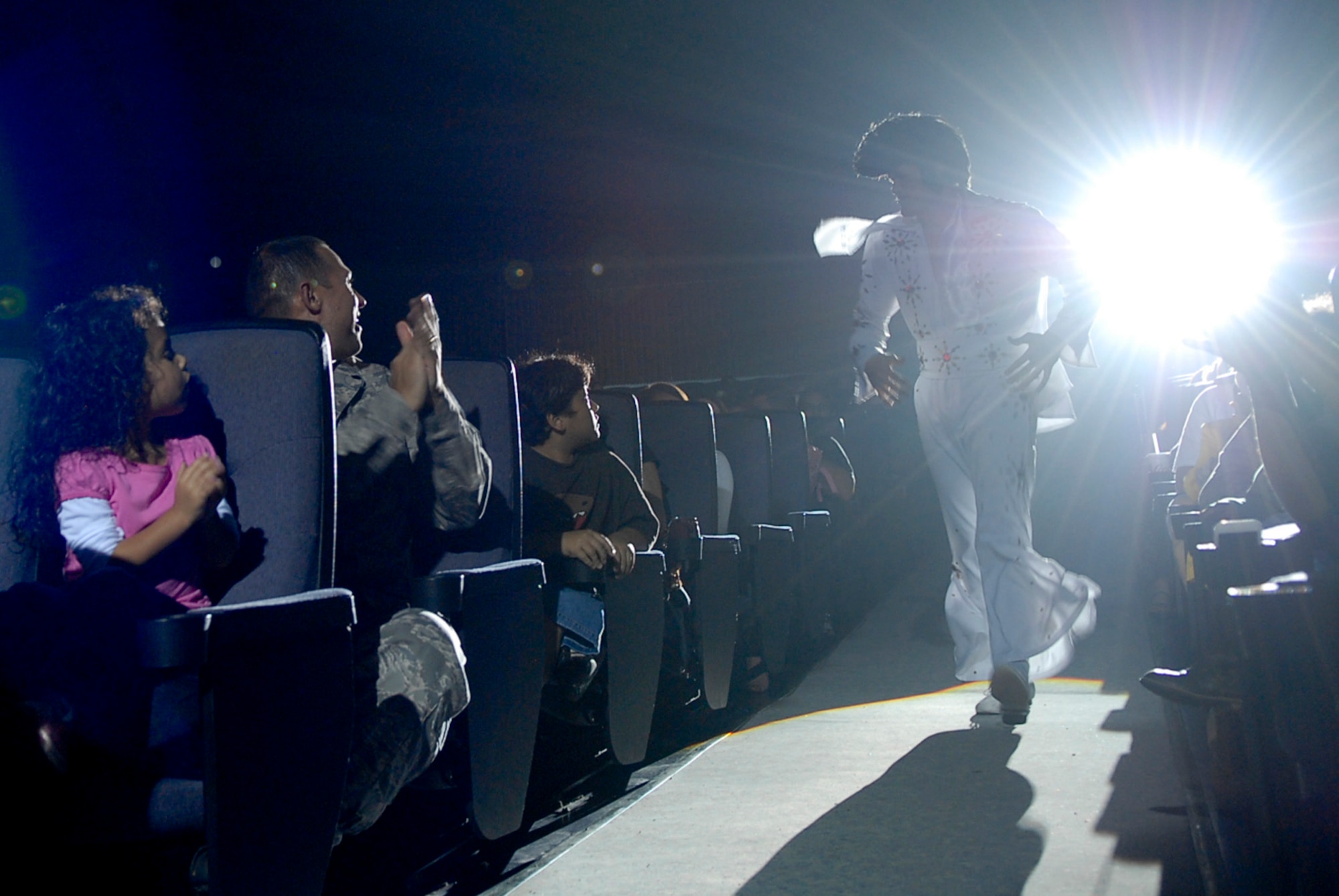 U.S. Air Force Senior Airman Cordero Nichols, Tops in Blue 2011 vocalist, makes his way to the stage through the crowd as Elvis Presley during a performance at the Keystone Theater on Kadena Air Base, Japan, Nov. 17, 2011. The 2011 world tour is entitled Rhythm Nation, as it takes the audience through an evolution of music throughout the decades. Nichols is a 301st Intelligence Squadron communications signals intelligence production journeyman from Misawa Air Base, Japan, and a Pleasant Hills, Mo., native. (U.S. Air Force photo by Airman 1st Class Tara A. Williamson/Released)