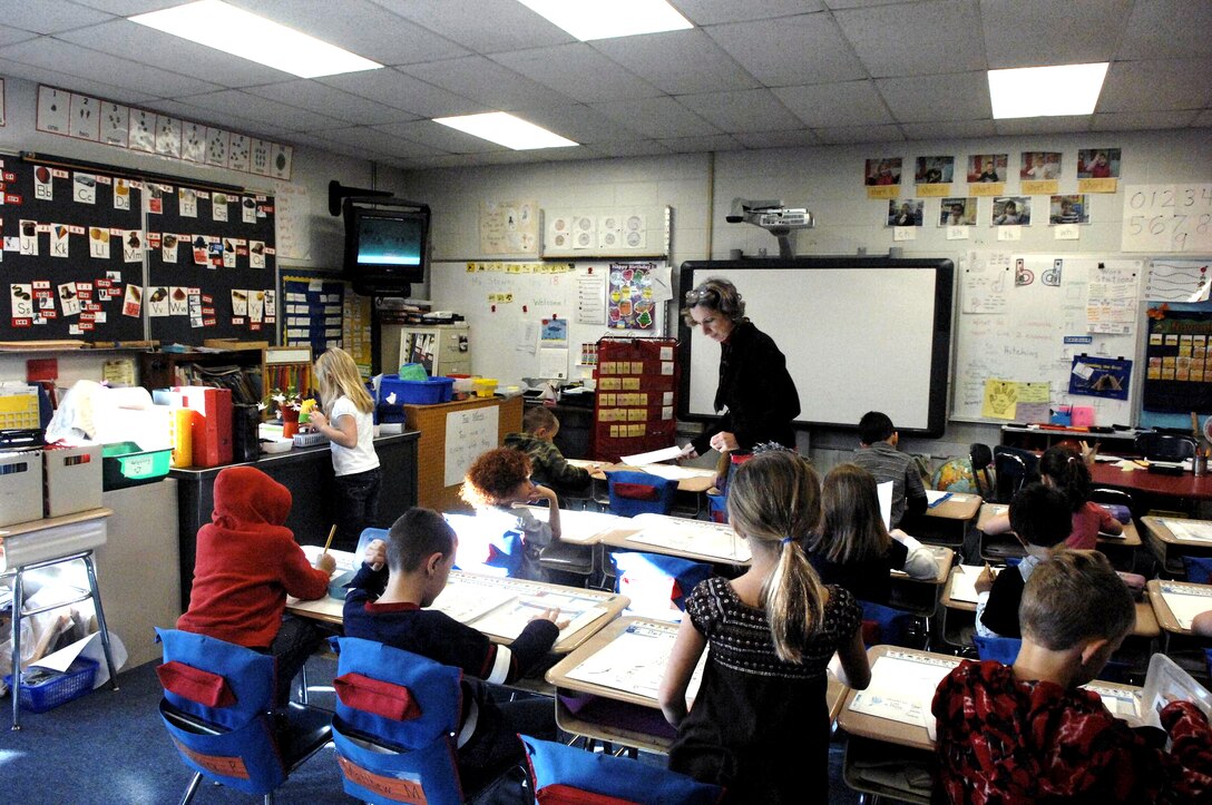 Tamar Stearns works with her first-grade students at Dr. Charles G. Barnum Elementary School during class in Groton, Conn., near Submarine Base New London, Nov. 18, 2011. School officials have developed a strong support program for military children, who make up 90 percent of the student body. DOD photo by Army Sgt. 1st Class Tyrone C. Marshall Jr.