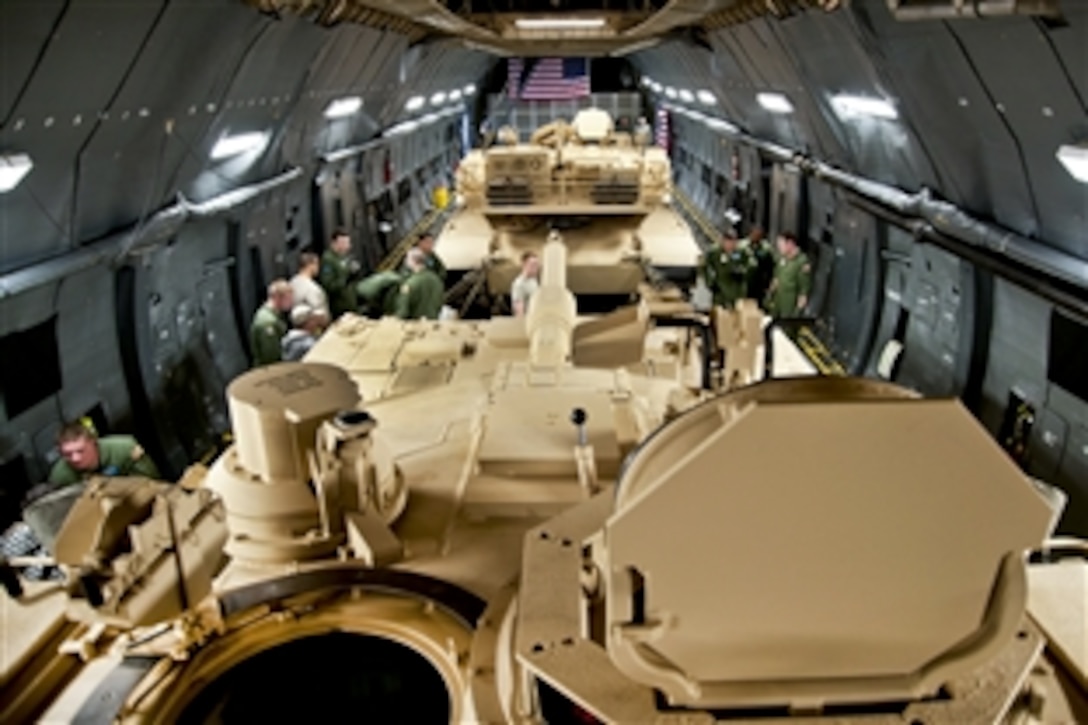 Two M-1 Abrams tanks from Aberdeen Proving Ground, Md., sit in the cargo area of a C-5M Super Galaxy assigned to Dover Air Force Base, Del., Nov. 15, 2011. The Super Galaxy has new GE CF6 engines, providing 22 percent more thrust and cutting climb time in half. New lighting in the cargo area increases safety of loading and offloading cargo.
