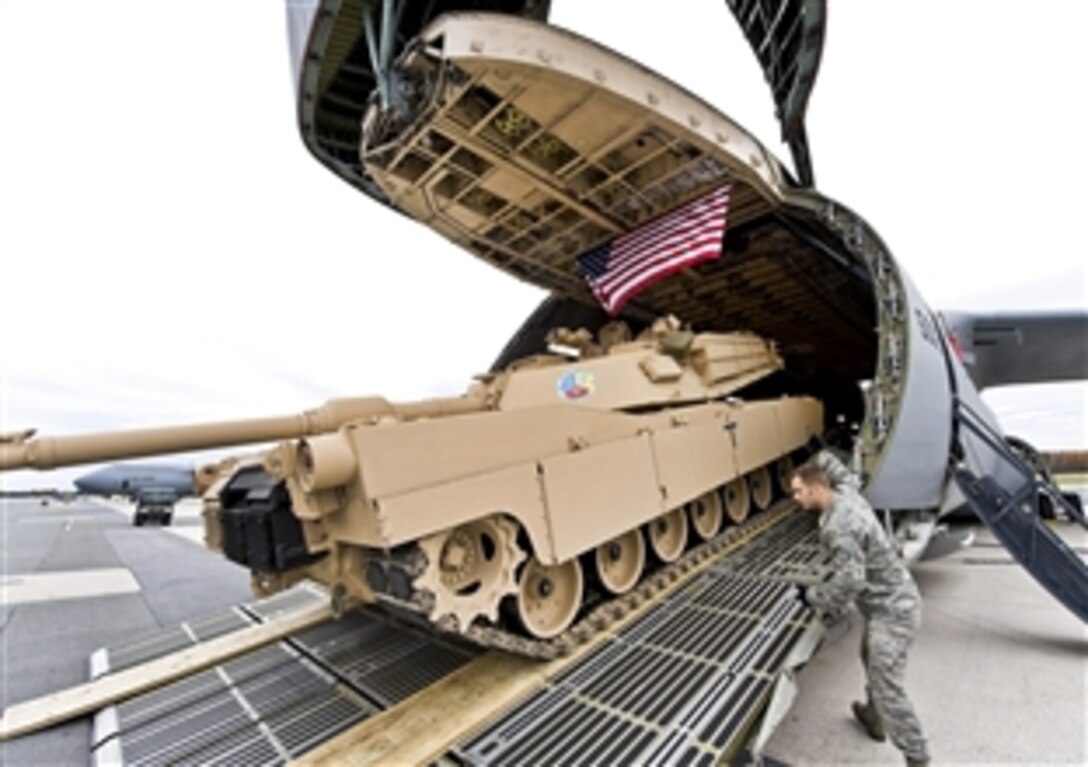 Airmen load a tank into a C-5M Super Galaxy on Dover Air Force Base, Del., Nov. 15, 2011. The C-5M is the upgraded version of the C-5 Galaxy and has a 30 percent shorter takeoff roll and 58 percent faster climb rate. It also can carry more cargo over longer distances.