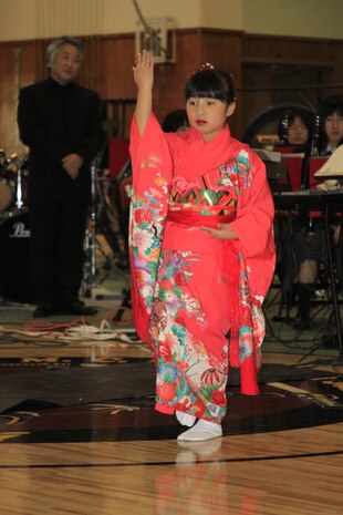 Juri Tanabe, 8, a member of the Shunan International  Children’s Club, Children Dance Division, performs a Japanese dance in the gymnasium at the Mathew C. Perry Elementary School here Nov. 23. The Japanese peformers came to visit as a way of saying thank you for the support the school gave during operation Tomodachi.