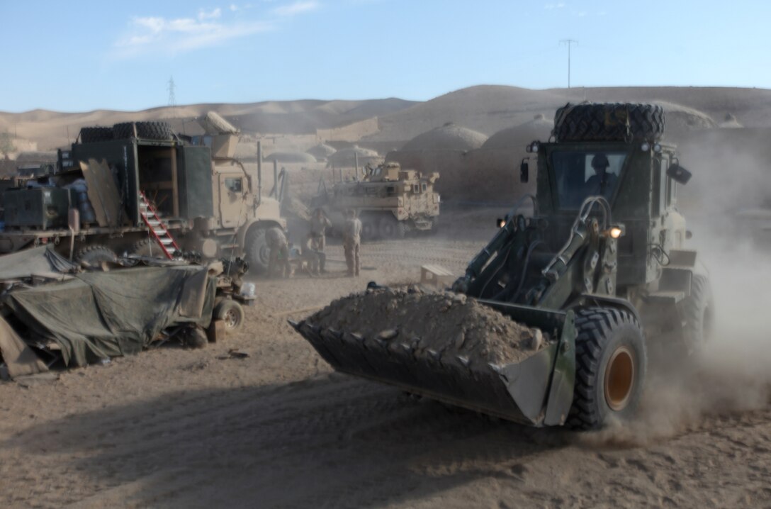 A heavy equipment operator with Combat Logistics Company 6, 2nd Marine Logistics Group (Forward), uses a front loader to haul gravel for a landing zone at Forward Operating Base New Jersey, Afghanistan, Nov. 23. The company, which is comprised of two engineer platoons and one motor transportation platoon, is an element of Combat Logistics Battalion 6 and was formed to provide direct support to 1st Battalion, 6th Marine Regiment, during Operation Eastern Storm. CLC-6 engineers built several of the patrol bases along Route 611. (U.S. Marine Corps photo by Sgt. Justin J. Shemanski)