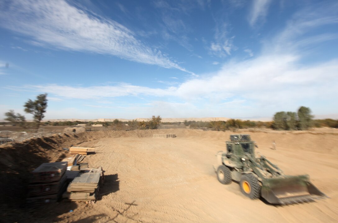 A lone heavy equipment operator with Combat Logistics Company 6, 2nd Marine Logistics Group (Forward), uses a front loader to finish work on a landing zone at Forward Operating Base New Jersey, Afghanistan, Nov. 23. The company, which is comprised of two engineer platoons and one motor transportation platoon, is an element of Combat Logistics Battalion 6 and was formed to provide direct support to 1st Battalion, 6th Marine Regiment, during Operation Eastern Storm. CLC-6 engineers built several of the patrol bases along Route 611. (U.S. Marine Corps photo by Sgt. Justin J. Shemanski)