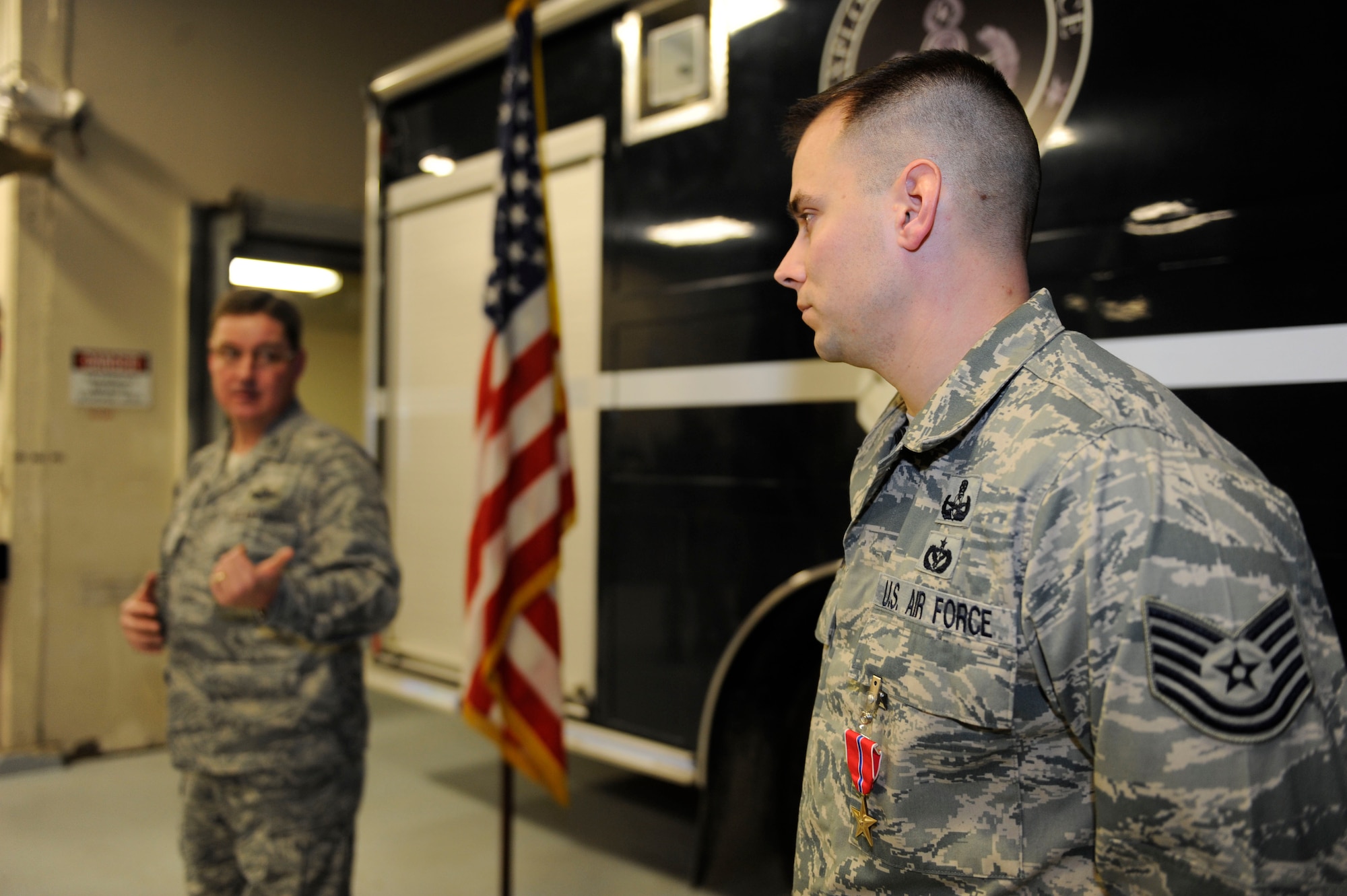 Col. Robert Evans congratulates Tech Sgt. Andrew Adrian on earning the Bronze Star in the 673rd Explosive Ordinance Disposal shop, Joint Base Elmendorf-Richardson, Alaska Nov. 18, 2011. Adrian disarmed more than 15 improvised explosive devices during his deployment in support of Operation Enduring Freedom in Afghanistan. Evans is the 673rd Air Base Wing and Joint Base Elmendorf-Richardson commander. Adrian is an Explosive Ordinance Disposal team leader. (U.S. Air Force photo/Staff Sgt Robert Barnett)