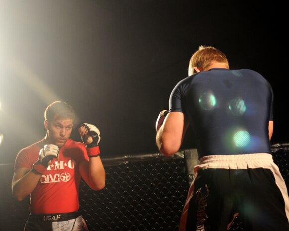 Staff Sgt. Alan Wood, left, Air Force reservist, circles the ring with his opponent during the Galaxy Fight Night at Champions Indoor Soccer Arena in Yuba City, Calif. Nov. 19, 2011. Fighters wait to see who will make the first move and wait on an opening for a hit. (U.S. Air Force photo by Airman 1st Class Samuel W. Sanders/Released)
