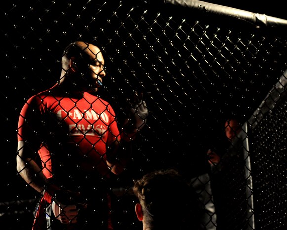 Staff Sgt. Francisco Garrigas, 9th Maintenance Group, inspects his gloves before a Mixed Martial Arts fight at Champions Indoor Soccer Arena in Yuba City, Calif. Nov. 19, 2011. Fighters wear gloves to prevent serious injury to their opponent and themselves. (U.S. Air Force photo by Airman 1st Class Samuel W. Sanders/Released)