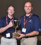 Majors Jeremy Sikora (left) and Shayne Stokes hold the FIT Bowl first place trophy after winning the competition Nov. 5, 2011, during the American College of Allergy, Asthma and Immunology Annual Meeting in Boston, Mass. The two Air Force doctors are allergy/immunology fellows assigned to the 59th Medical Operations Squadron, Lackland Air Force Base, Texas. (Courtesy photo)