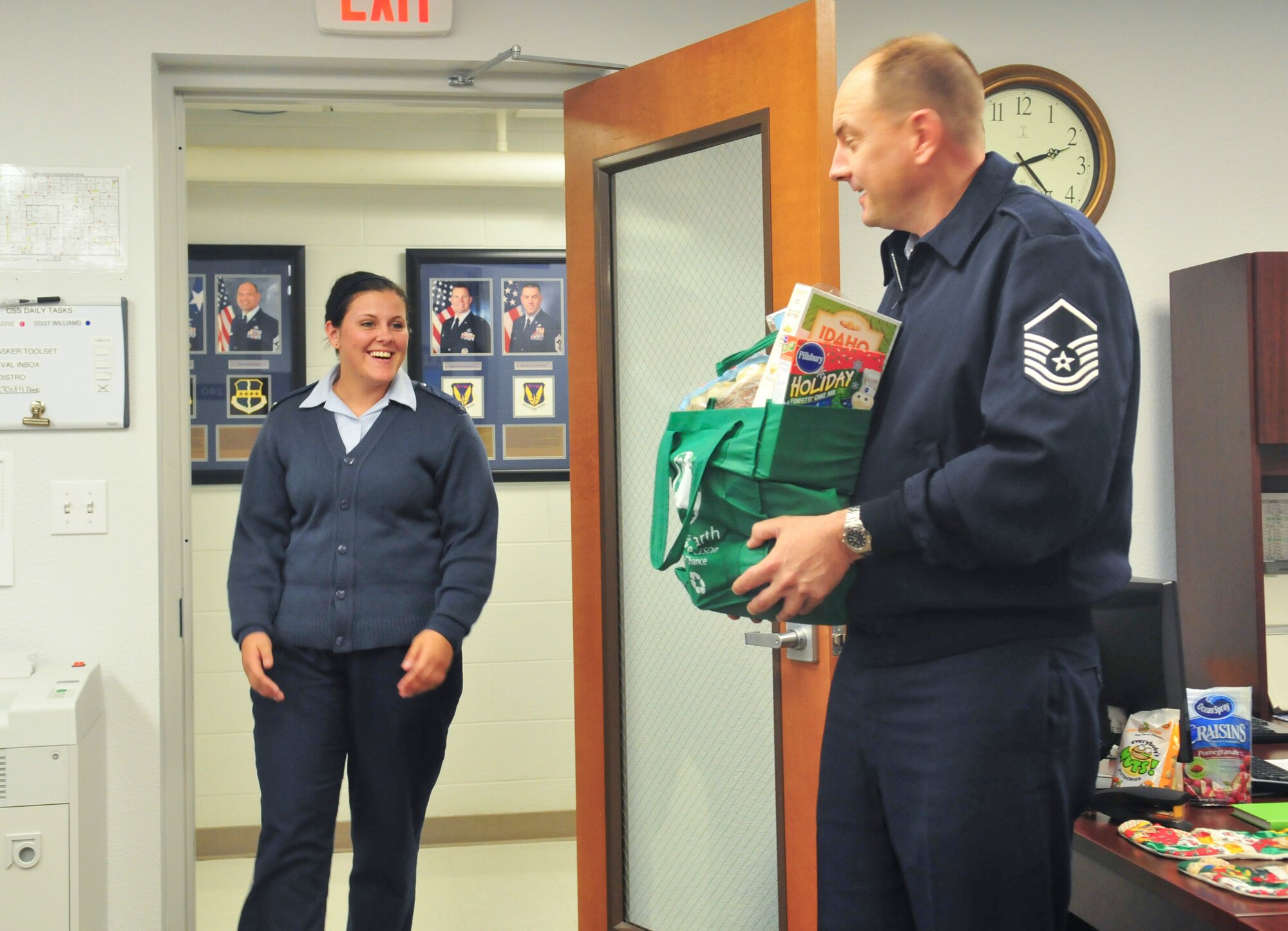 Master Sergeant Don Franken, a Beale first sergeant, surprises Senior Airman Sandra Healy with a bag of food Nov. 21, 2011 for the upcoming Thanksgiving holiday. The bag contained various side dishes, desserts and a sixteen pound turkey. (U.S. Air Force photo by Staff Sgt. Tinese Jackson/Released)