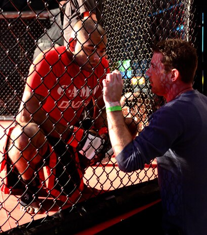 Staff Sgt. Francisco Garrigas, left, speaks with one of his coaches moments before he takes part in the Galaxy Fight Night, mixed martial arts competition, Yuba City, Calif. Nov. 19, 2011. Garrigas is one of three fighters from his gym to participate in the Galaxy Fight Night event. (U.S. Air Force photo by Airman 1st Class Ayla Ramirez/Released)