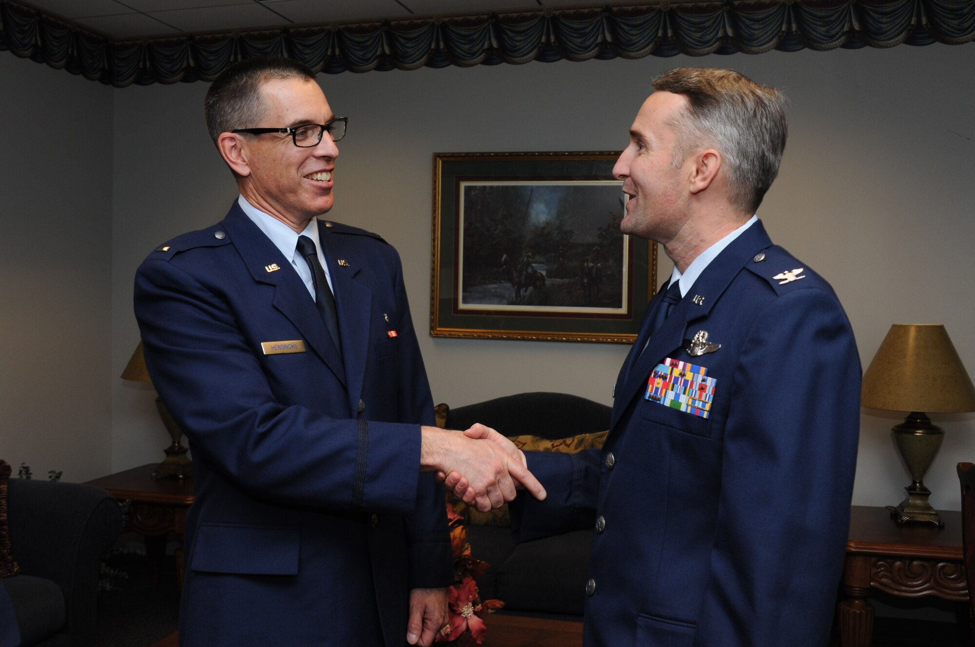 From left, 1st Lt. Christopher Hendricks is greeted by Col Thomas Coglitore, Officer Training School commander, Thursday after becoming the 20,000th Commissioned Officer Training graduate. 