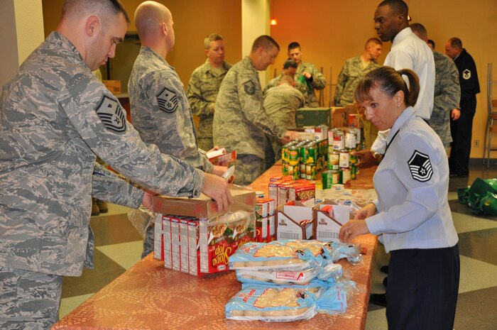 Members of the First Sergeants Council form an assembly line to help put together Thanksgiving turkey baskets for Airmen at the Community Activities Center at Beale Air Force Base Nov. 21, 2011. More than 200 baskets were made during the council’s Operation Warm Heart event. (U.S. Air Force photo by Staff Sgt. Robert M. Trujillo/Released)  