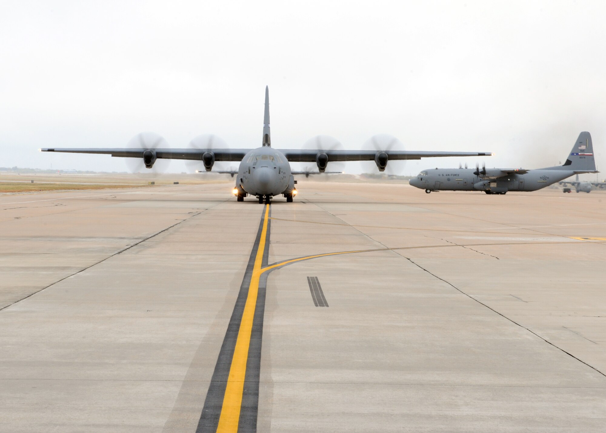 A fleet of C-130s prepare to take off during an airlift group exercise Nov. 22, 2011 at Dyess Air Force Base, Texas. Conducting exercises ensures airmen are capable of bringing support to foreign land. (U.S. Air Force photo by Airman 1st Class Jonathan Stefanko/ Released) 